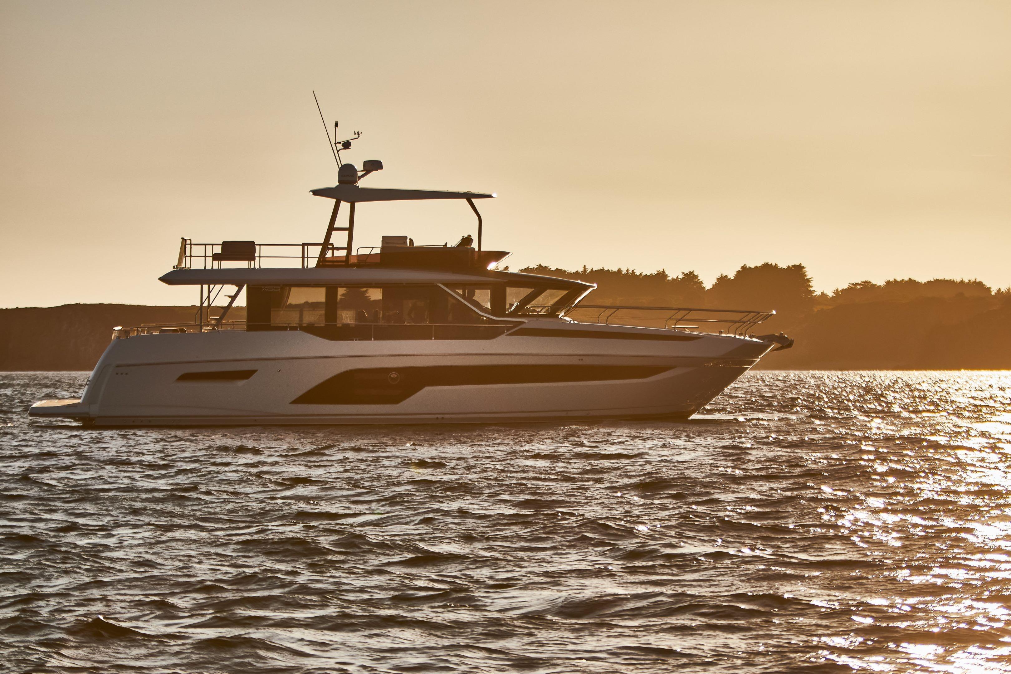 Luxury Prestige X60 yacht cruising at sunset, 2026 model, on serene waters.