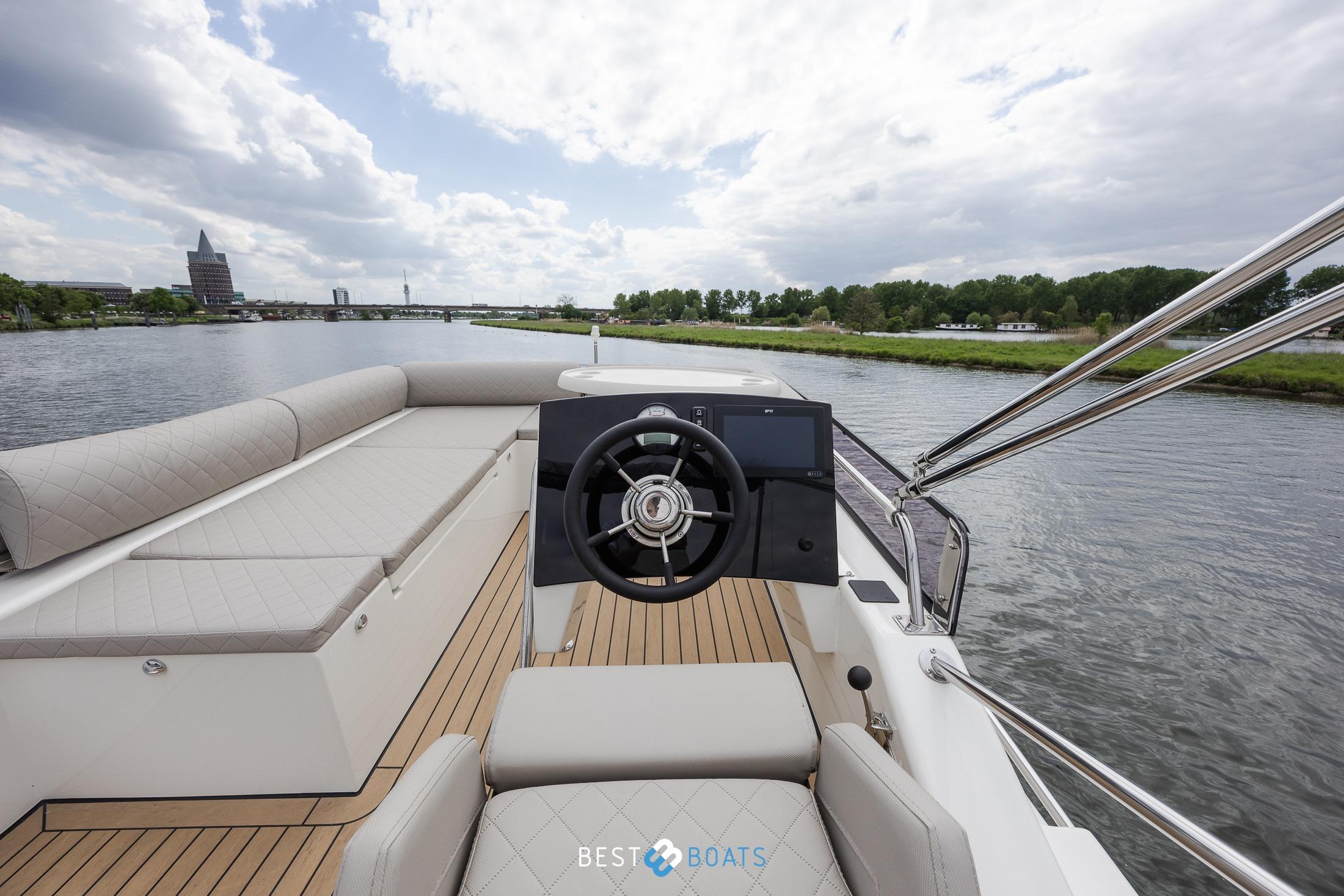 2023 Cobra Yachts Futura 36 Premium Fly, elegant helm on serene river.