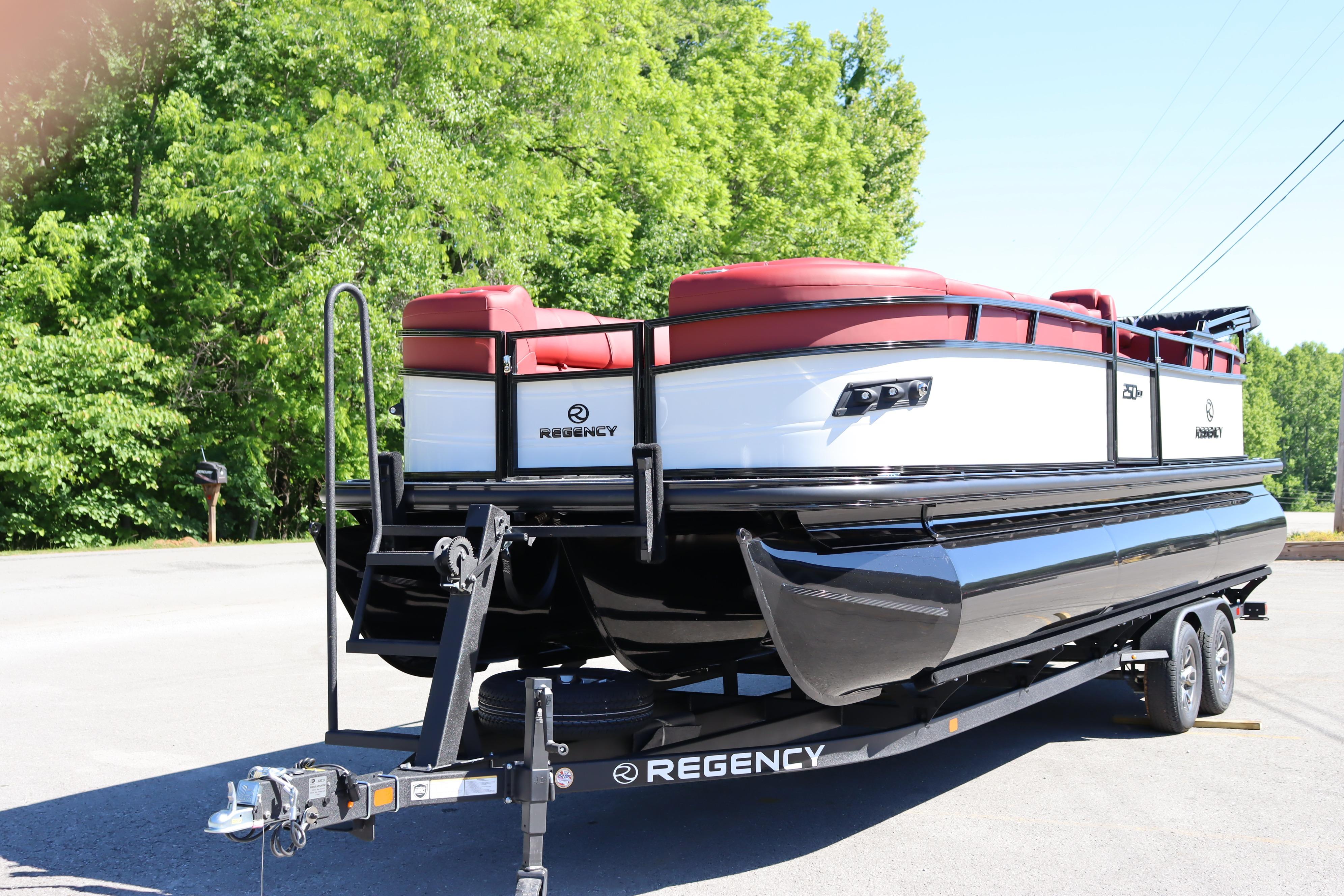 2026 Regency 250 DL pontoon boat on trailer, parked outdoors.