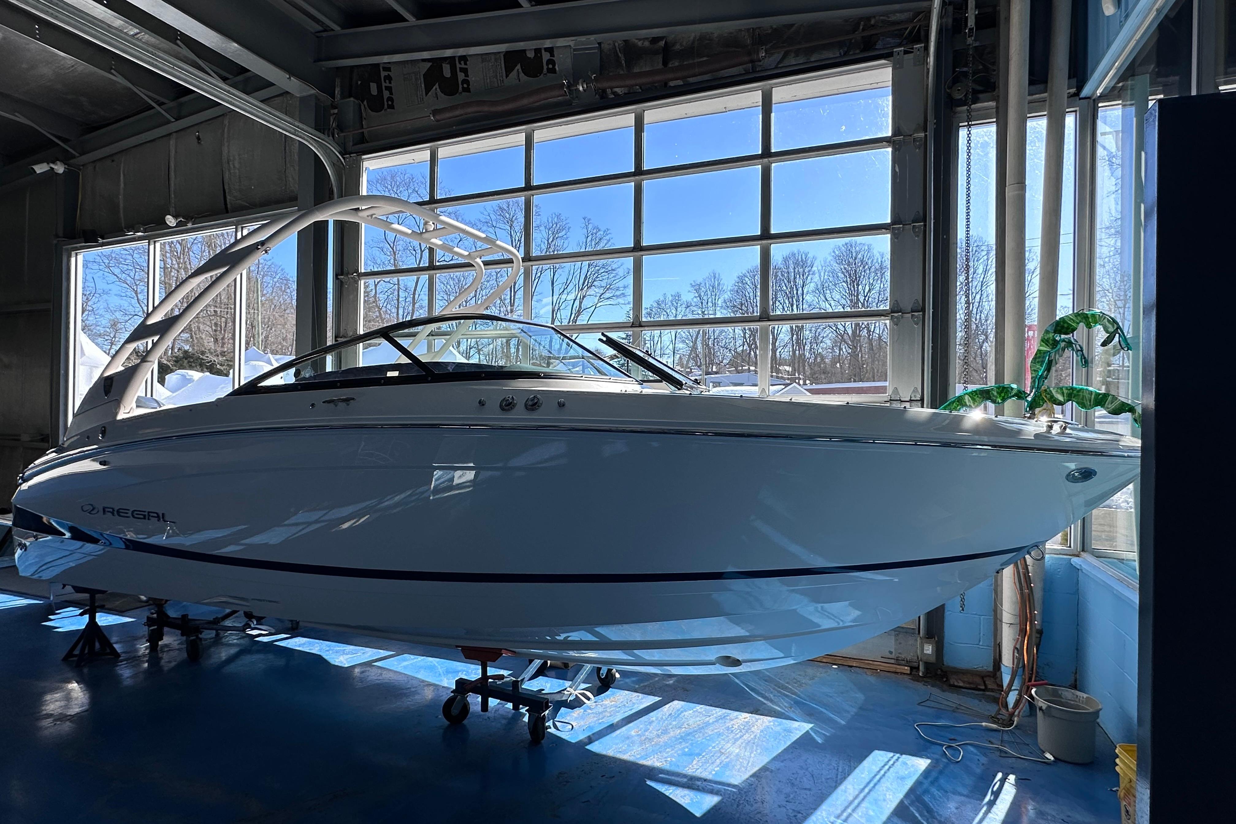 2026 Regal LX4 boat in a sunlit garage, showcasing sleek design and modern features.
