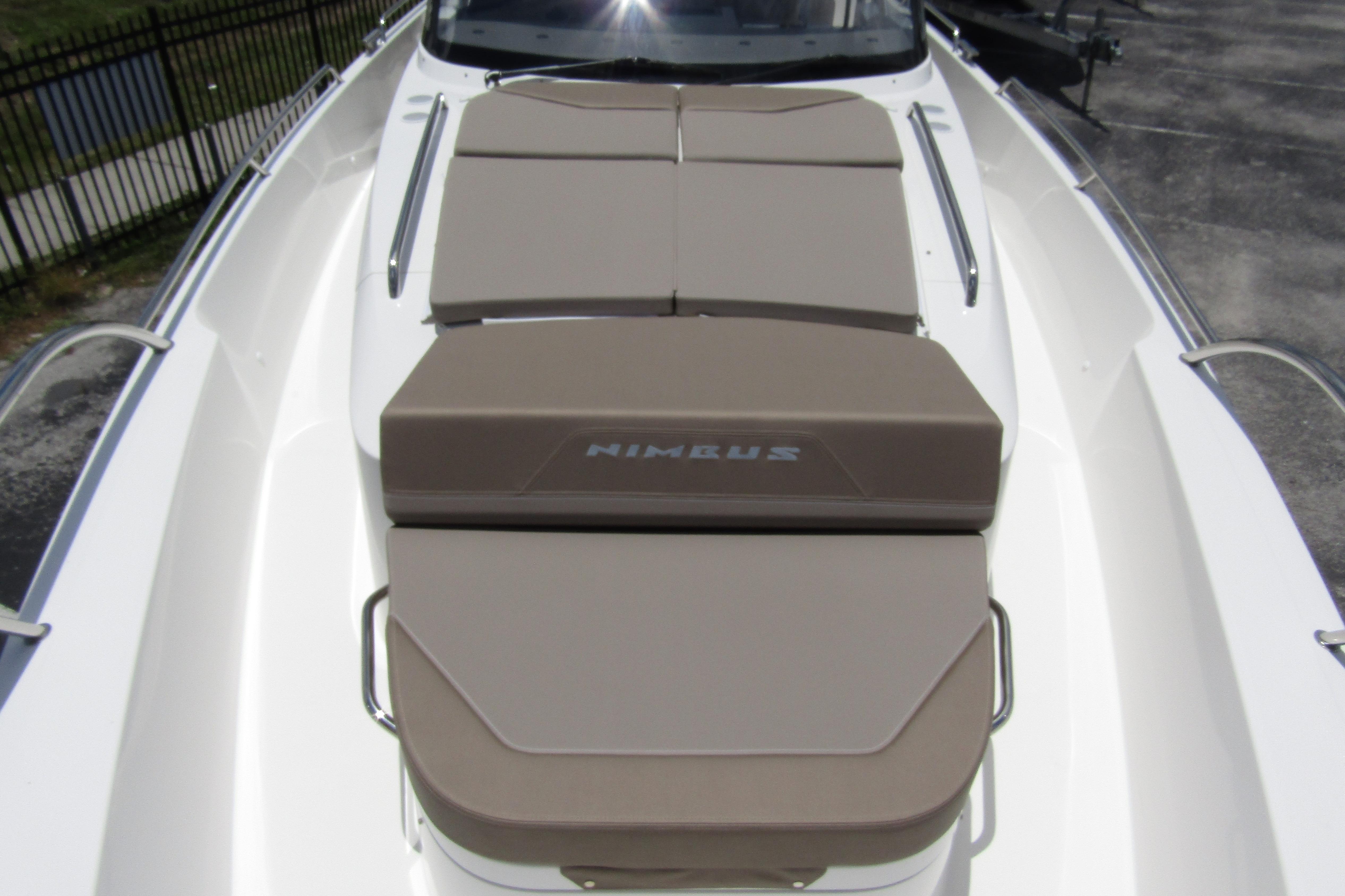 2025 Nimbus Tender 11 boat with cushioned sunbathing area on deck.