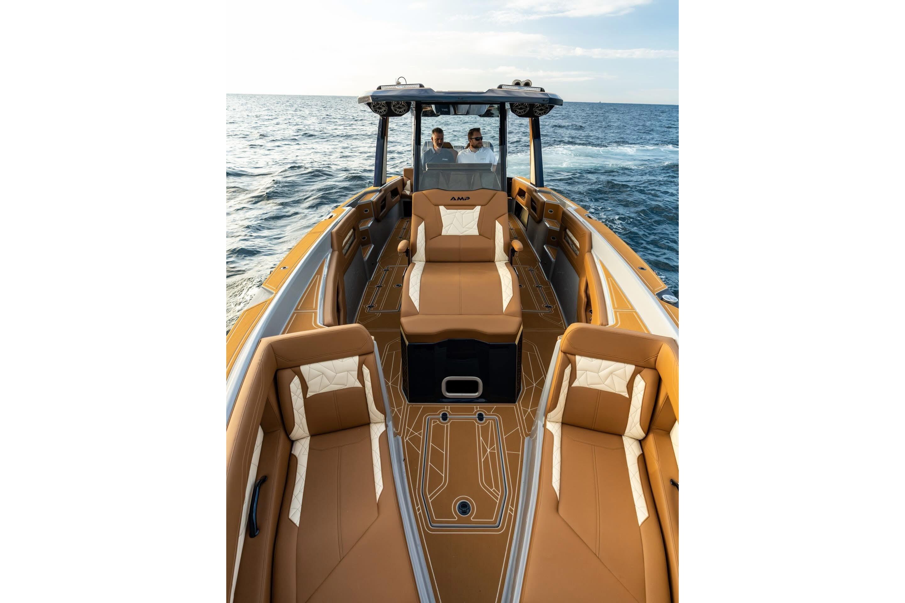 Luxurious AMP 34S boat interior, 2027 model, with tan seating on open water.