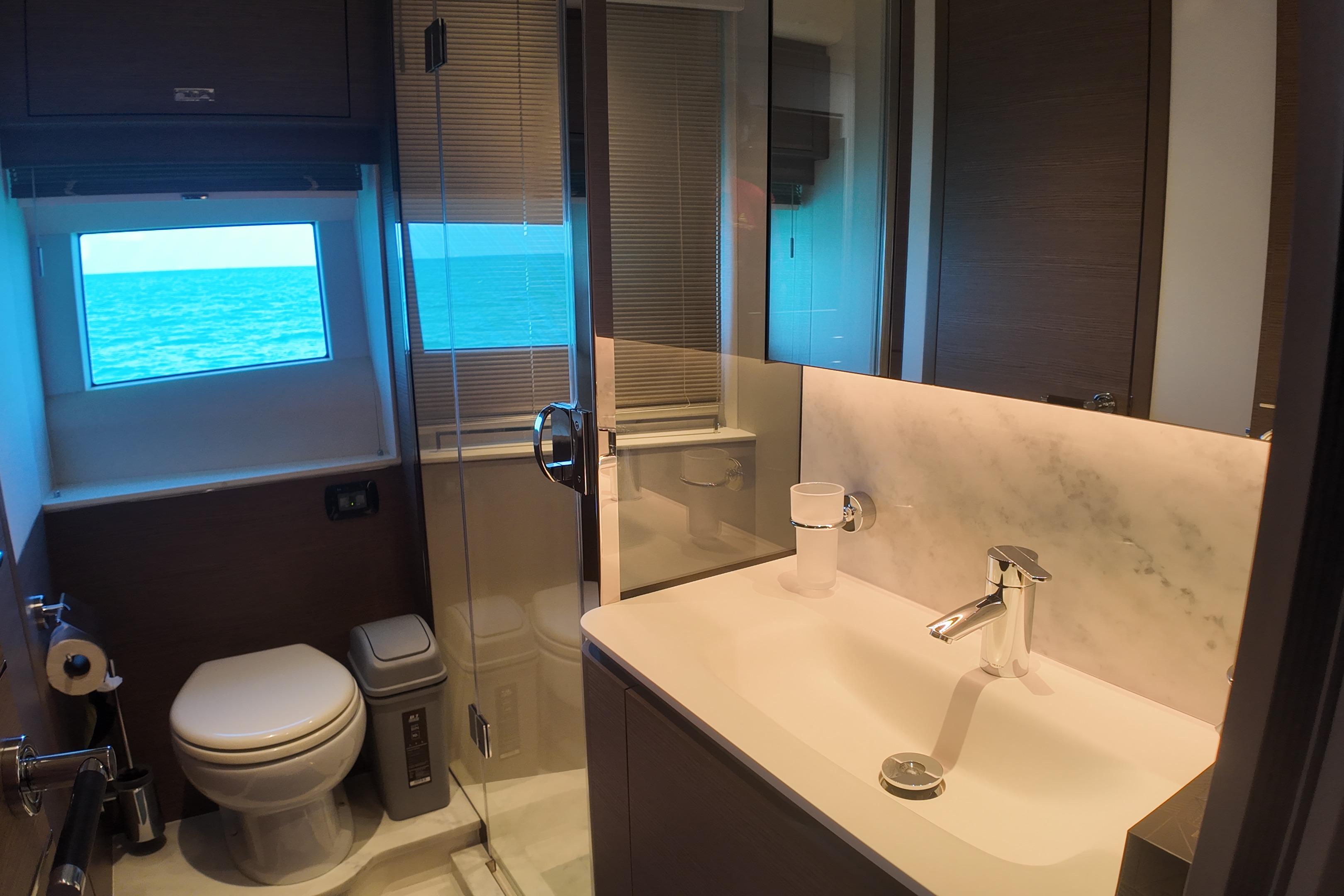 Luxurious bathroom on 2023 Princess Y72 yacht with ocean view window.