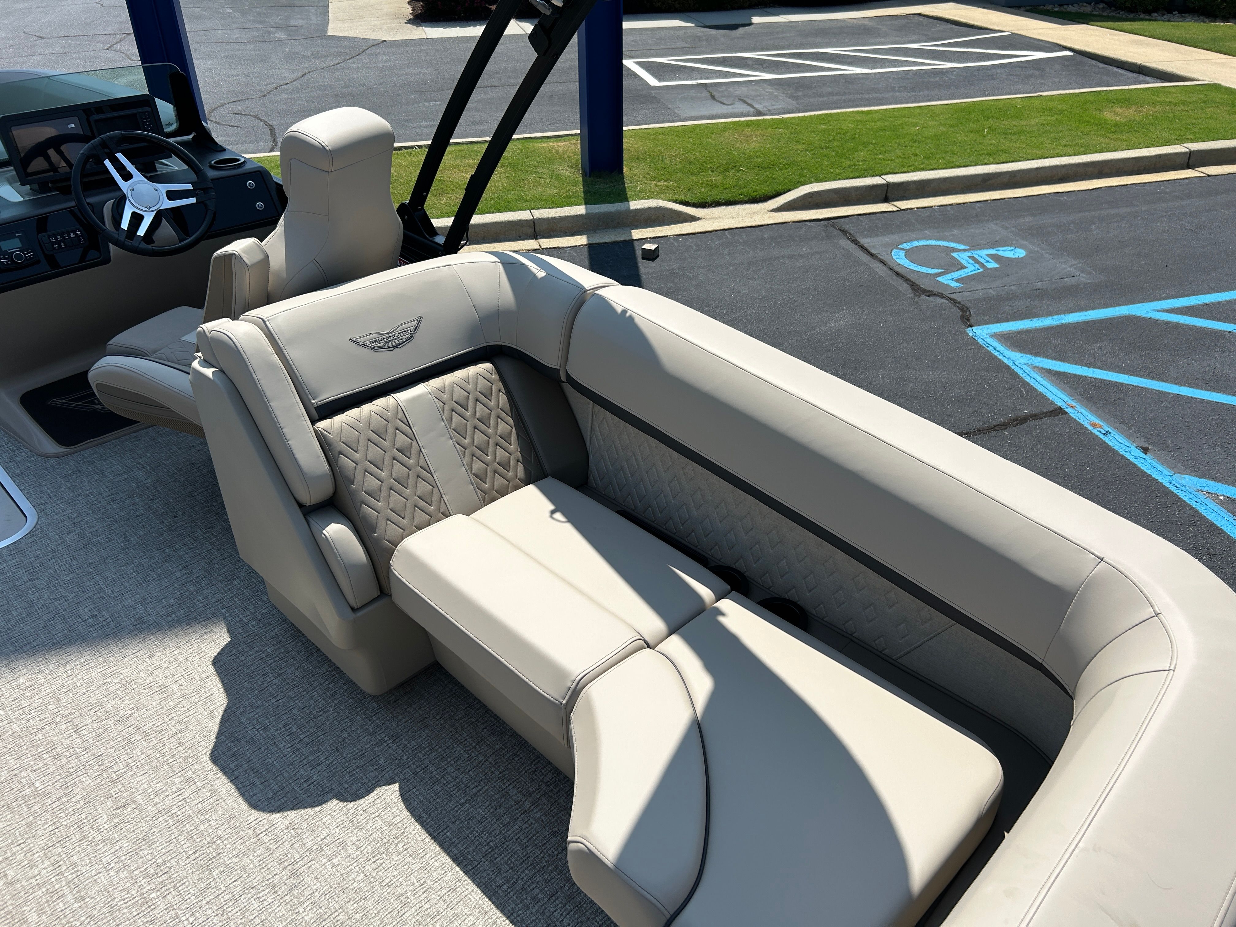 The image shows the luxurious interior of a Bennington 22 MFB boat with beige upholstery.