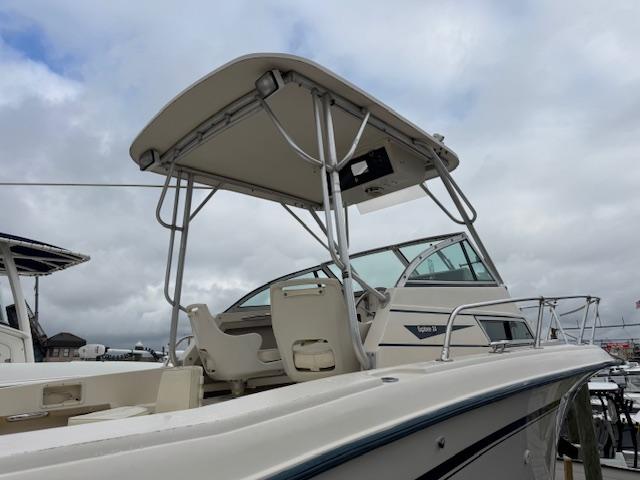 1992 Grady-White Explorer 244 boat with canopy, docked under cloudy skies.