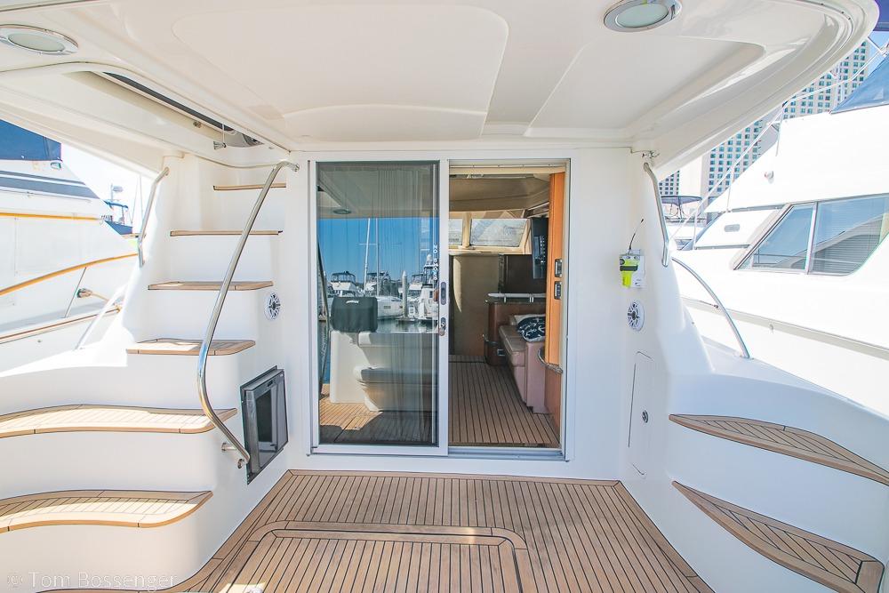 2005 Sea Ray 420 Sedan Bridge yacht interior with wooden deck and staircase.