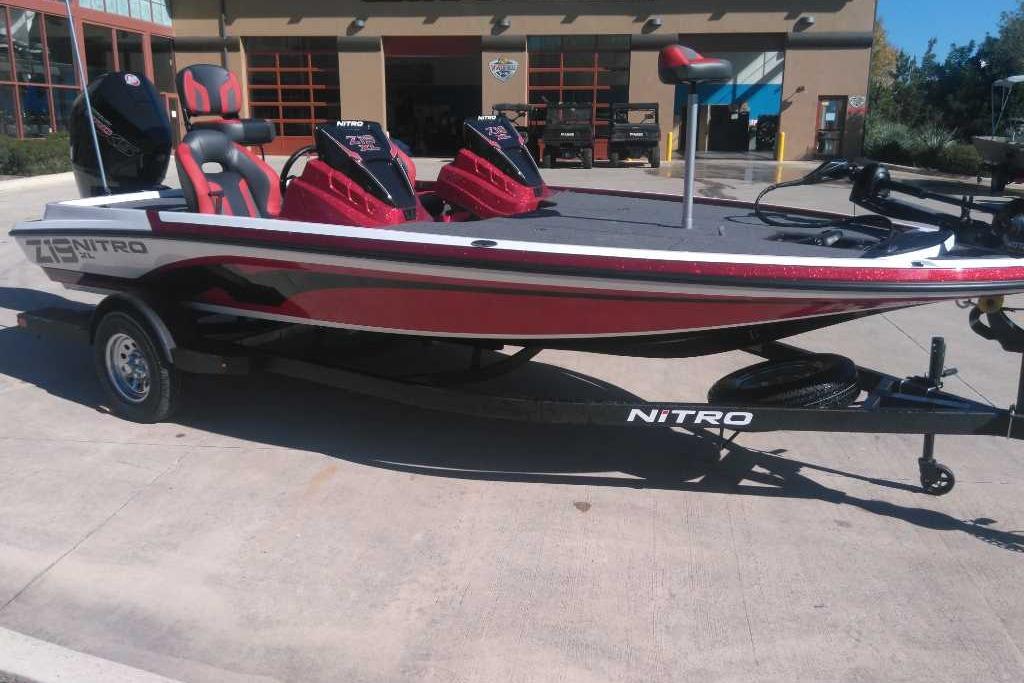 2026 Nitro Z19 XL boat with red and black design, parked on a trailer.
