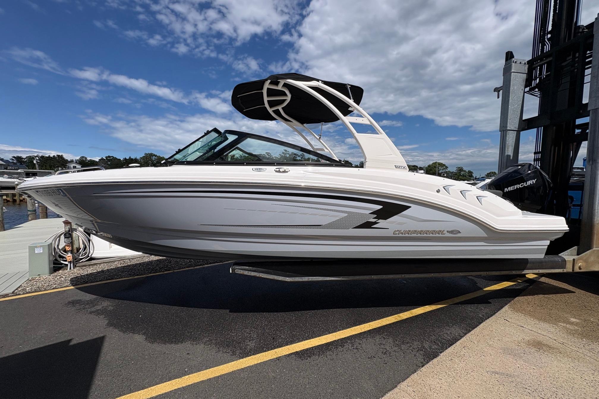 2026 Chaparral 23 SSi OB boat on dock under clear sky.