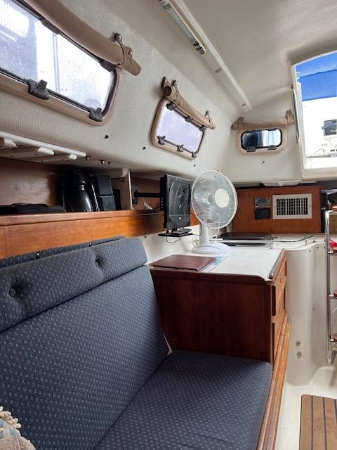 Interior of 1999 Contour 34 SC sailboat with seating and fan.