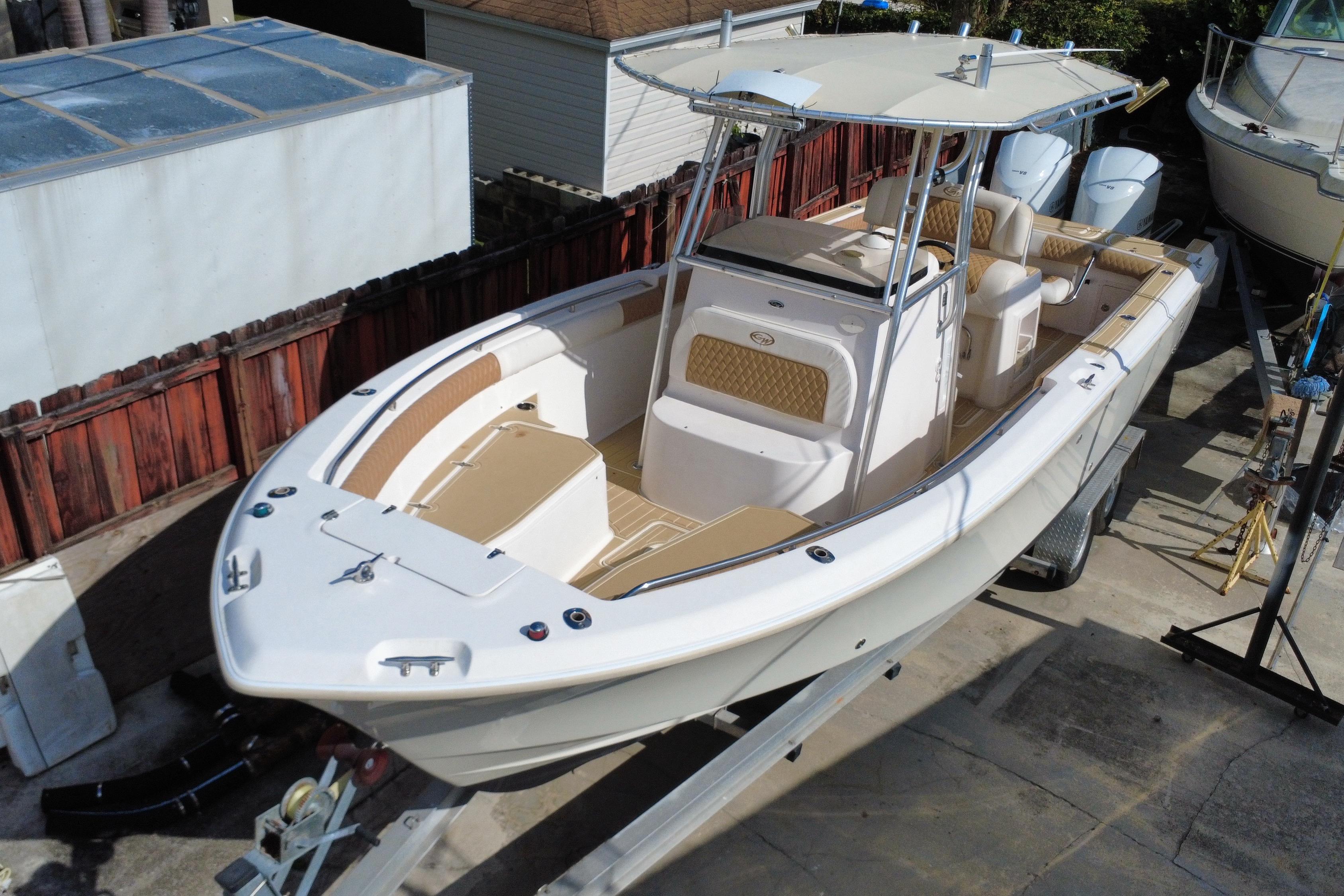 2004 Grady-White Canyon 283 boat on trailer, featuring spacious deck and dual engines.