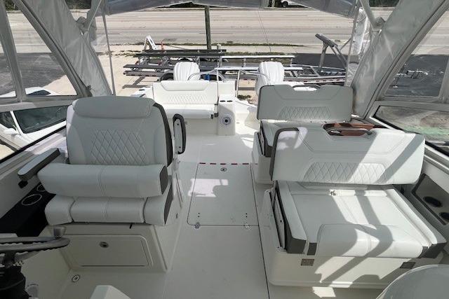 2023 World Cat 325 DC boat interior with white seating and helm station.