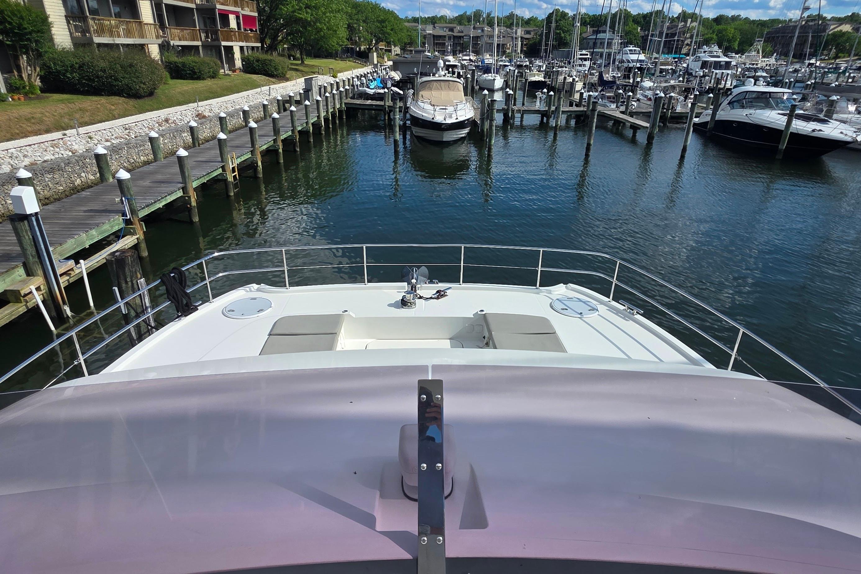 2018 Fountaine Pajot Motor Yacht 44 docked at a marina with scenic waterfront views.