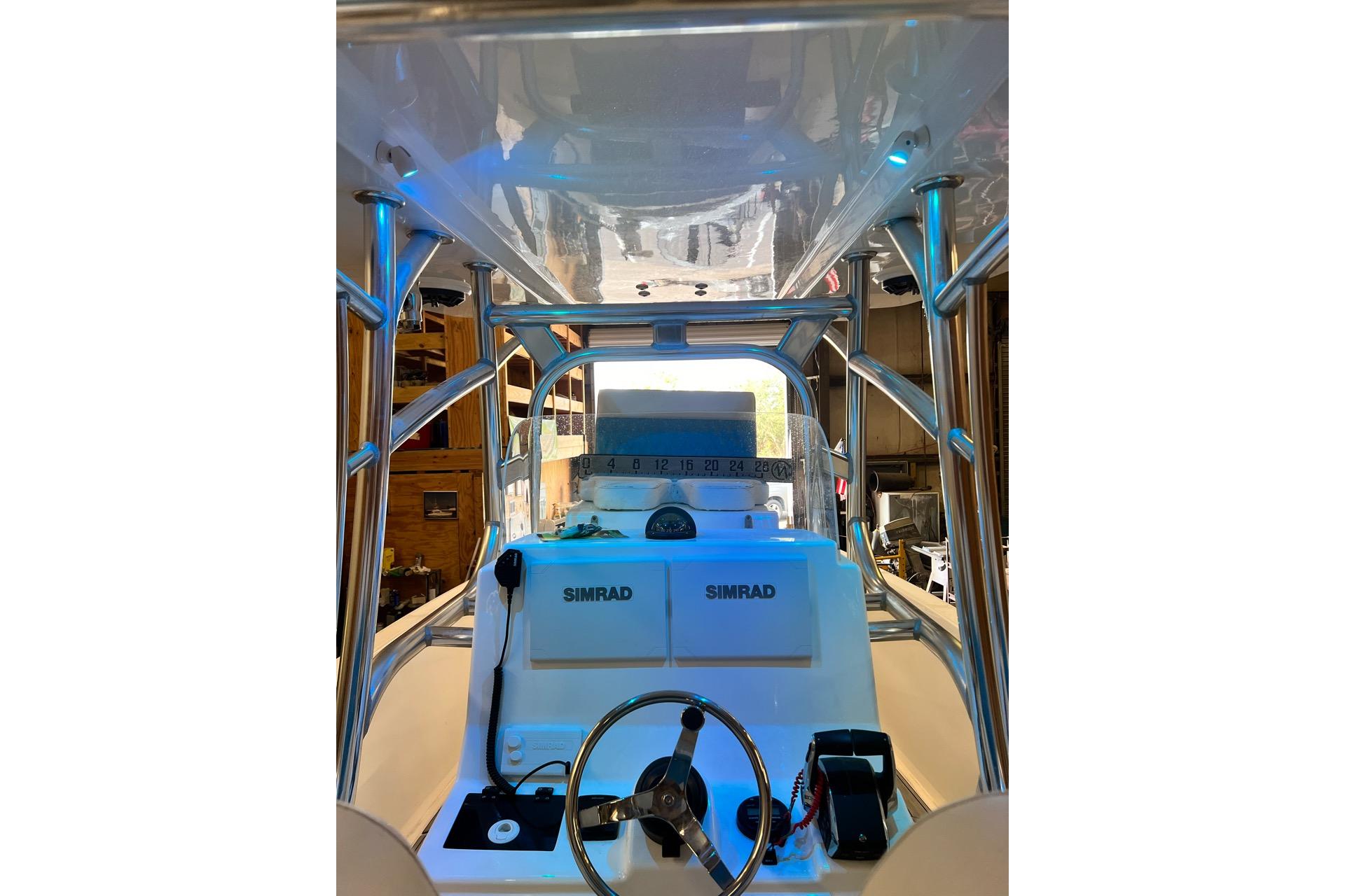 2021 Custom Infusion 34 CC boat dashboard with Simrad electronics and steering wheel.