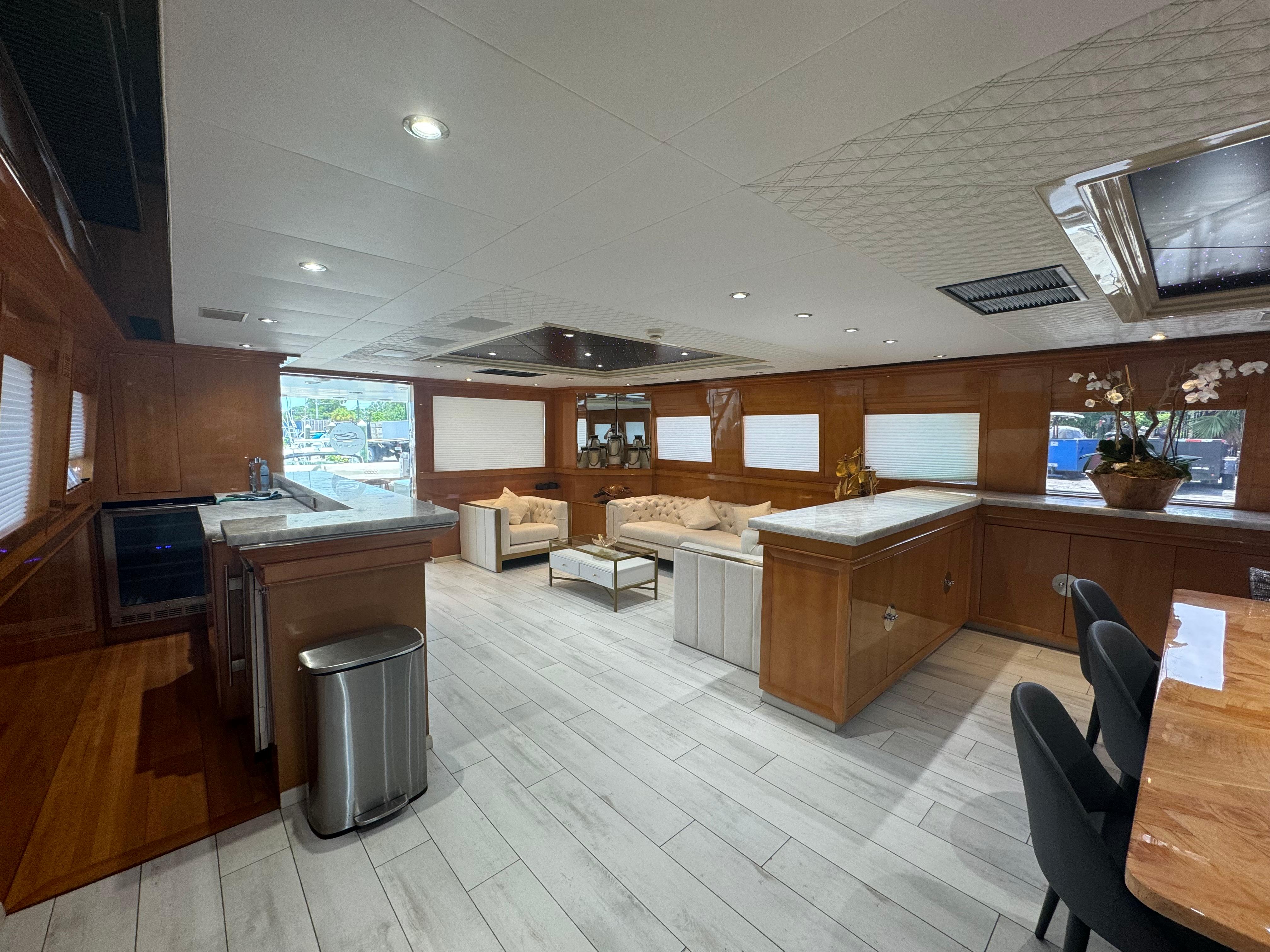 Luxurious interior of 2000 Baglietto 116 yacht with modern kitchen and seating area.