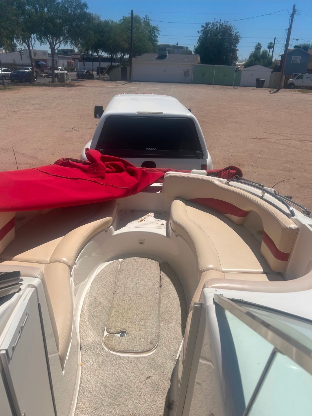 2001 Chaparral Sunesta 233 boat with red cover.
