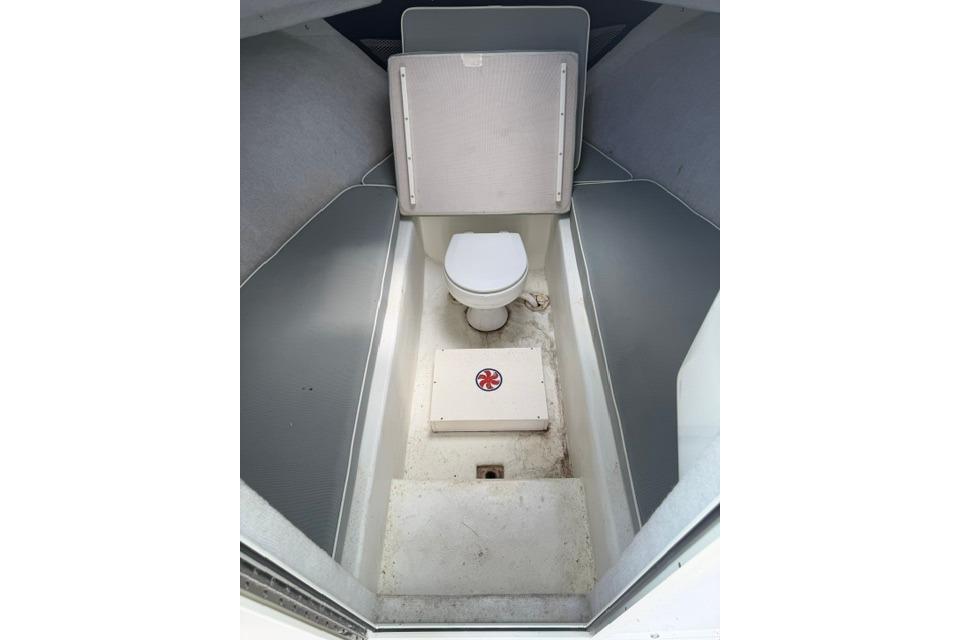 2016 Parker 2520 Sport Cabin interior with compact marine toilet.