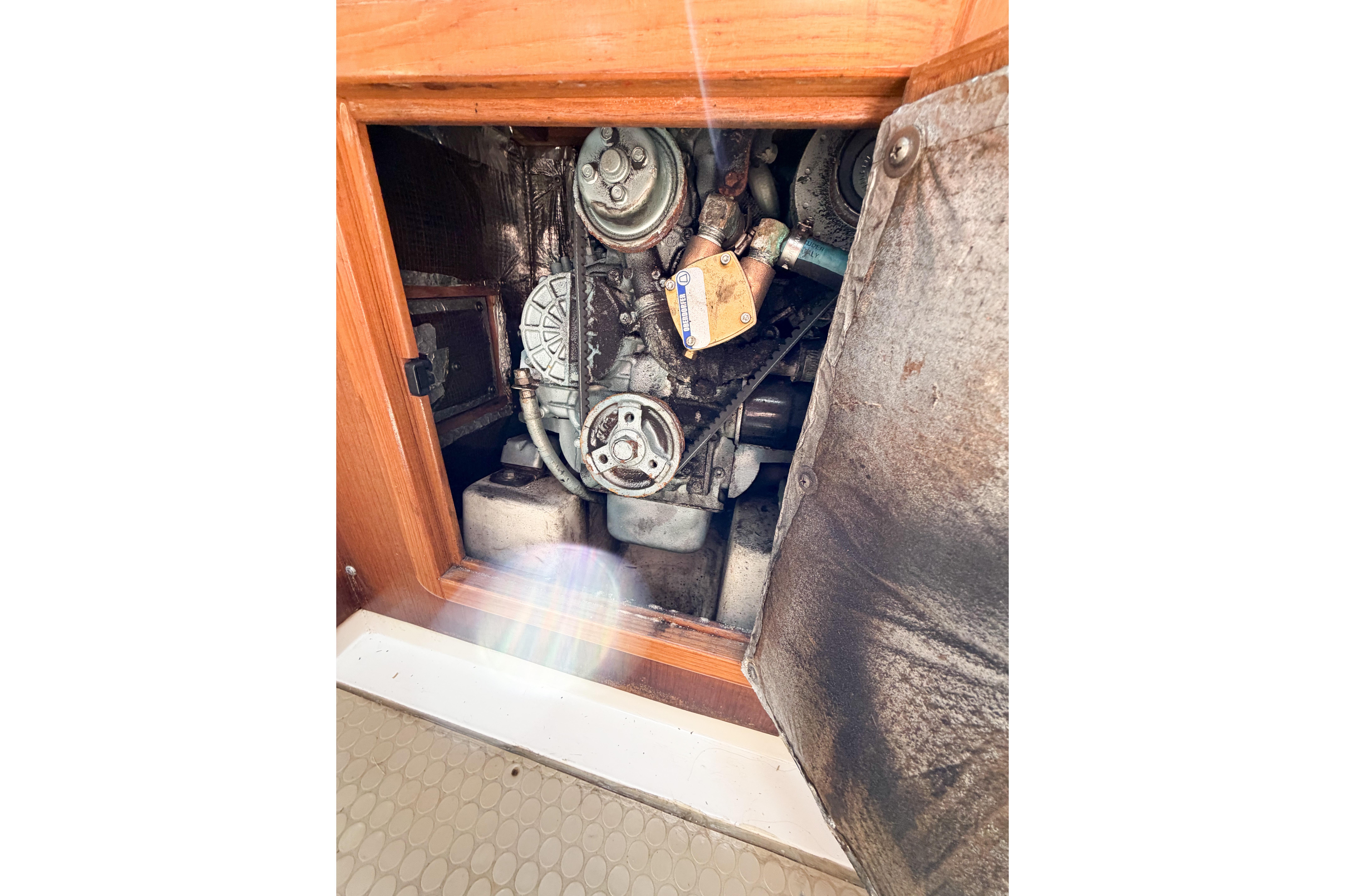 Engine compartment of a 2003 Catalina 34 MkII sailboat, showing mechanical components.