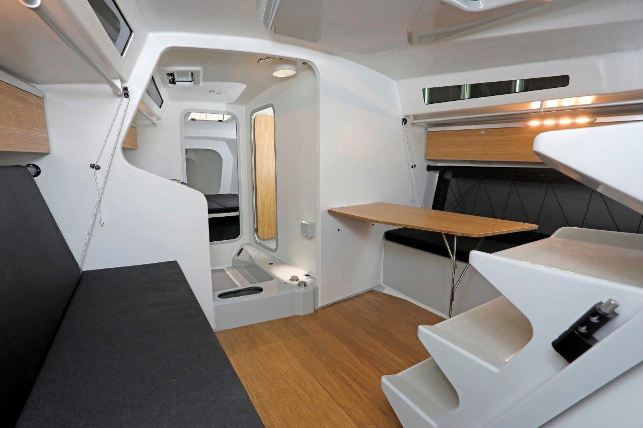 Modern interior of 2024 M.A.T. 1220 sailboat with sleek design and wooden accents.