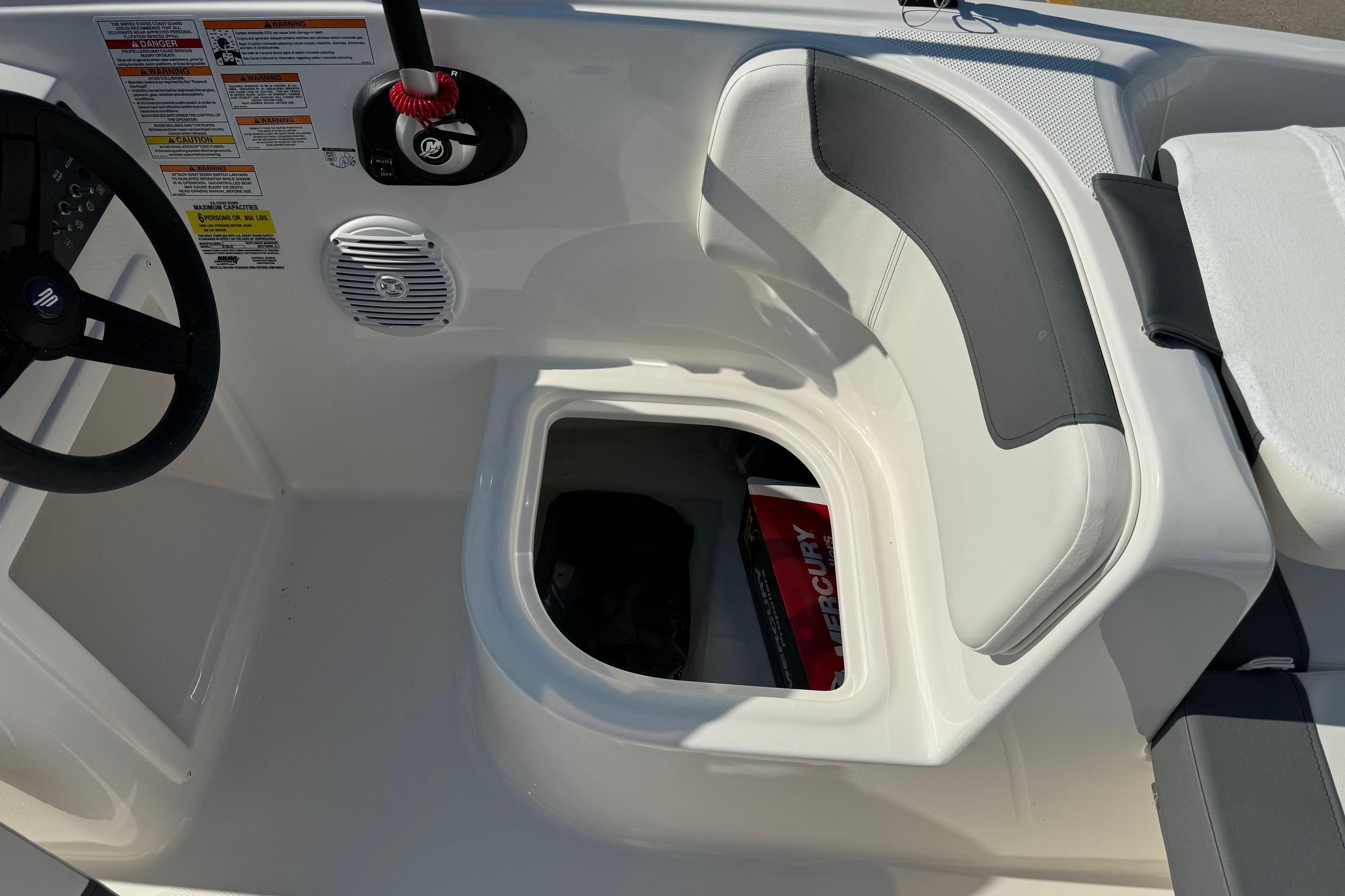 2025 Bayliner Element E16 boat interior with steering wheel and storage compartment.