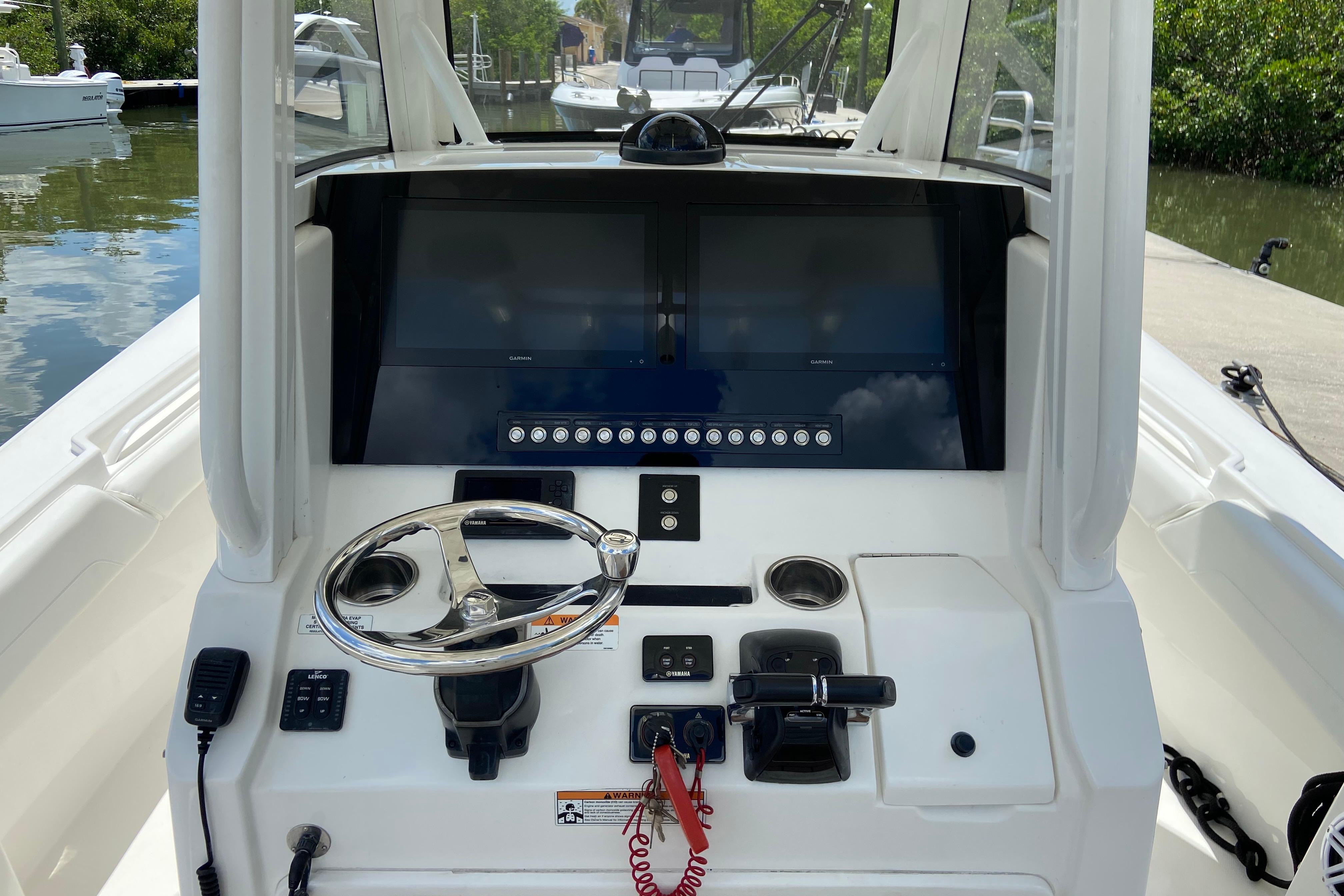 2021 Regulator 28 boat helm with steering wheel and navigation screens.