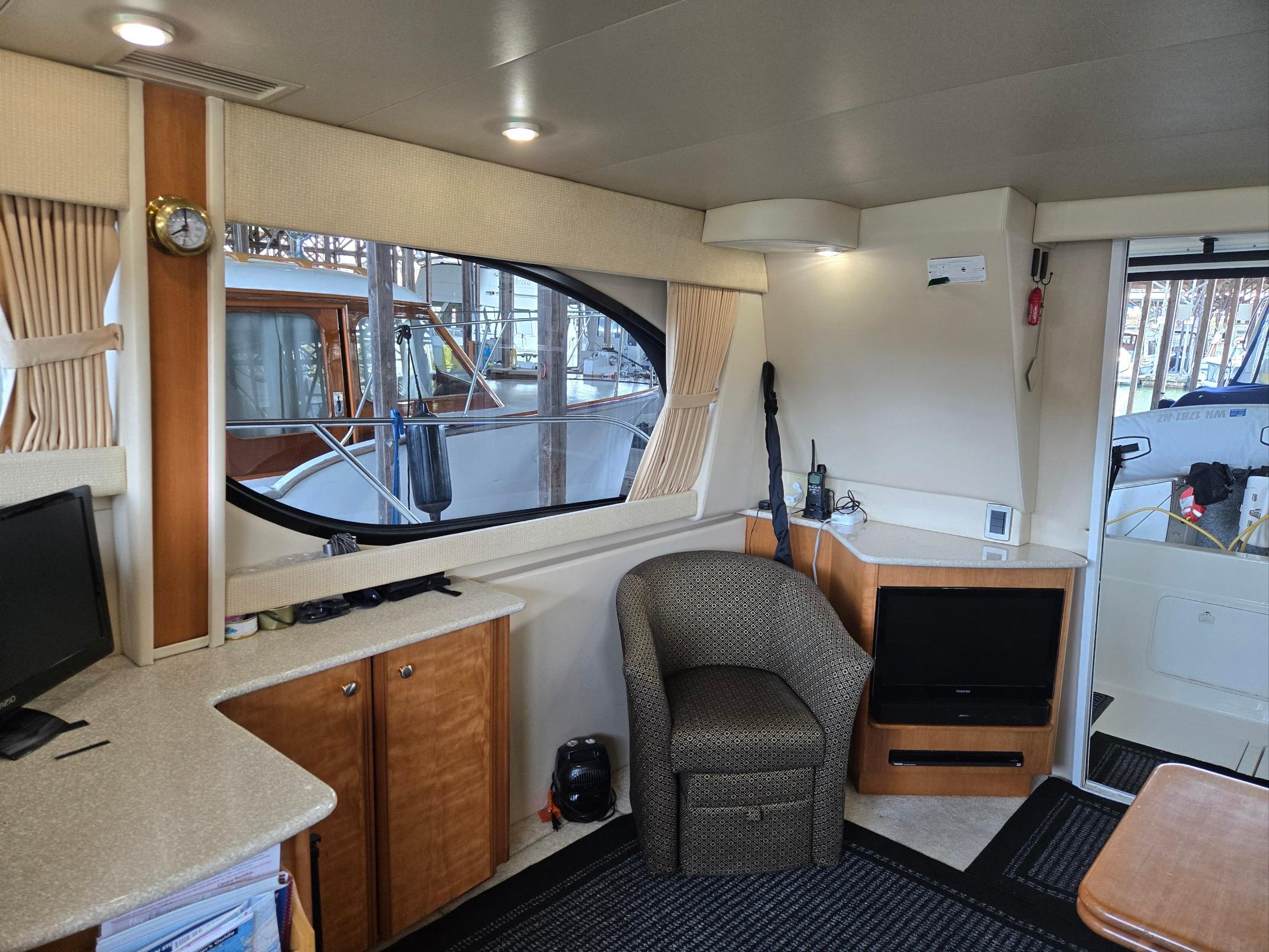 Interior of 2004 Meridian 381 Sedan yacht with cozy seating and modern amenities.