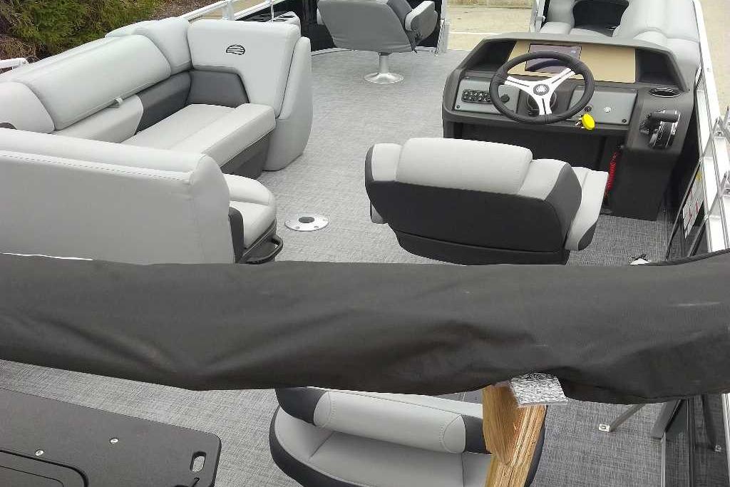2026 Sun Tracker SportFish 20 DLX interior with gray seating and steering console.
