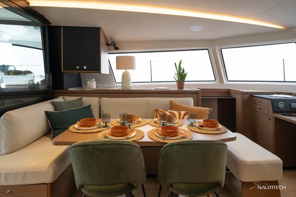 Luxurious interior of 2025 Nautitech 48 Open yacht with elegant dining setup and modern decor.