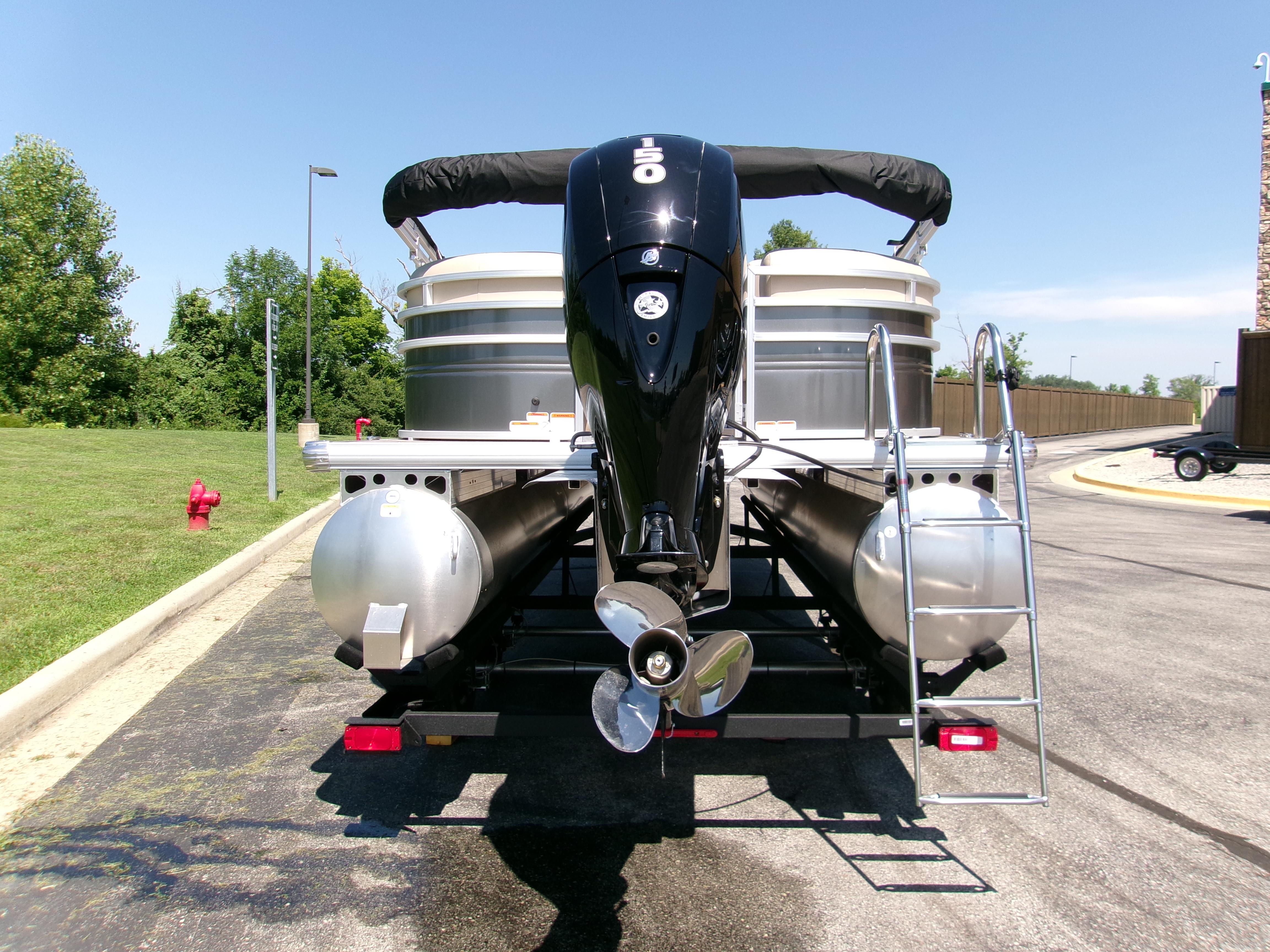 2025 Sun Tracker Party Barge 22 DLX pontoon boat with outboard motor and ladder.