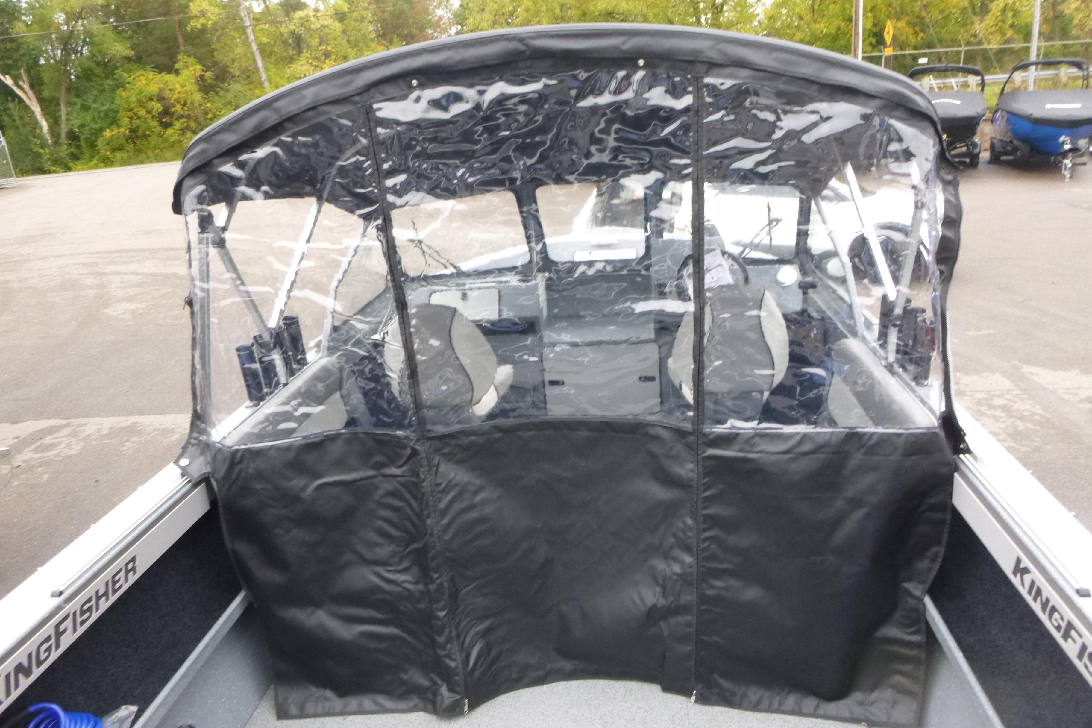 KingFisher 2025 Escape boat with protective canopy, 2026 model, parked outdoors.