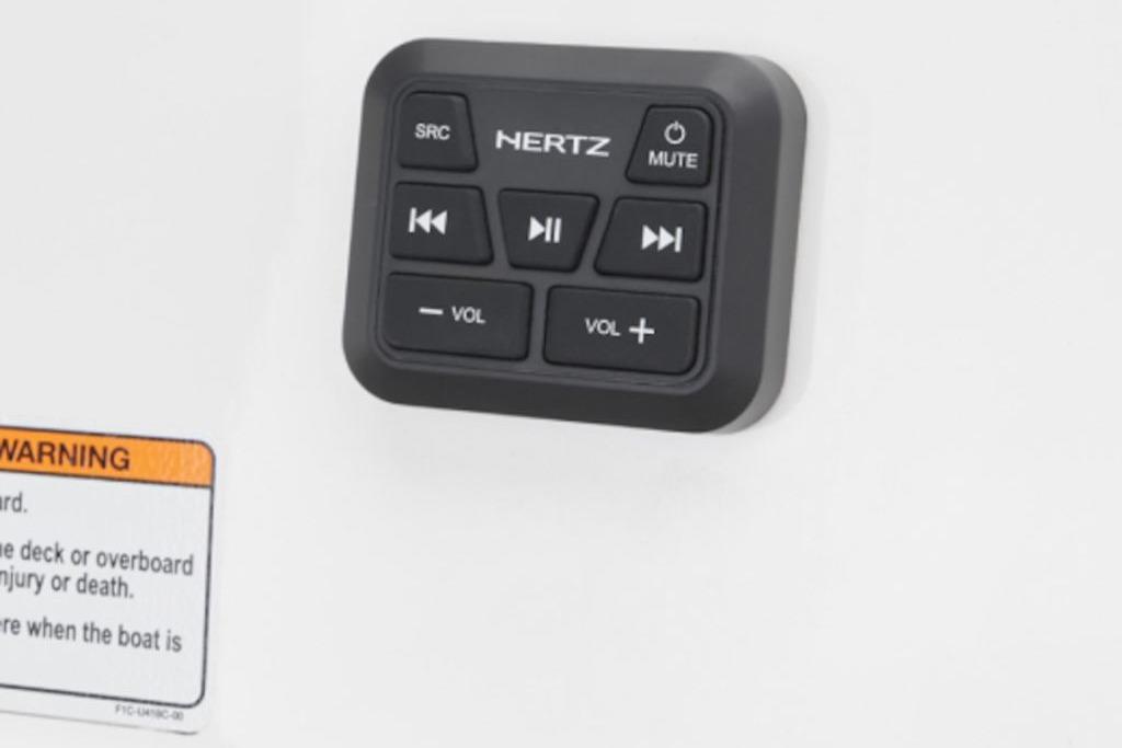 Control panel on 2026 Yamaha Boats 195S, featuring audio controls and warning label.