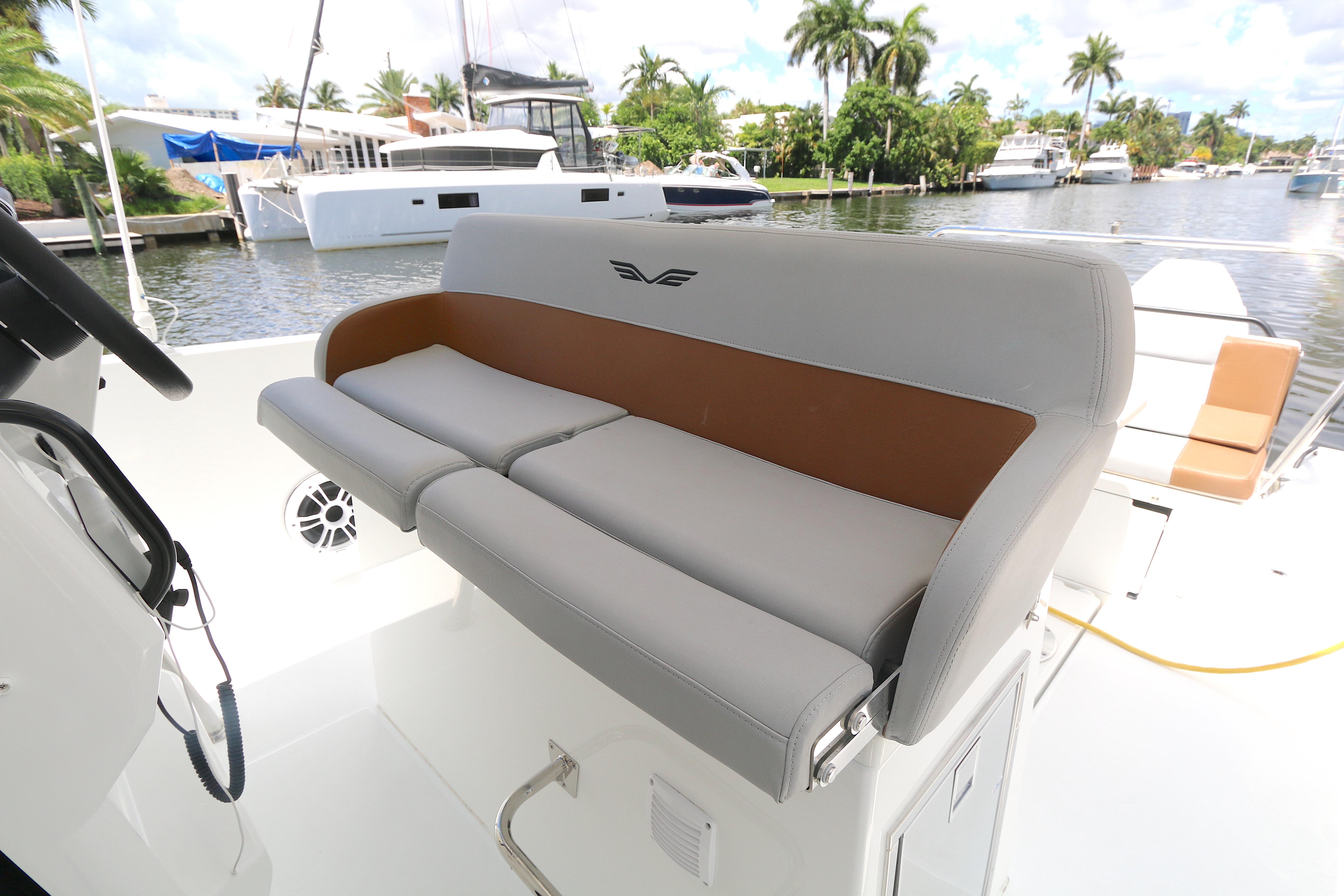 2022 Beneteau Flyer 9 SPACEdeck boat interior with cushioned seating by the water.