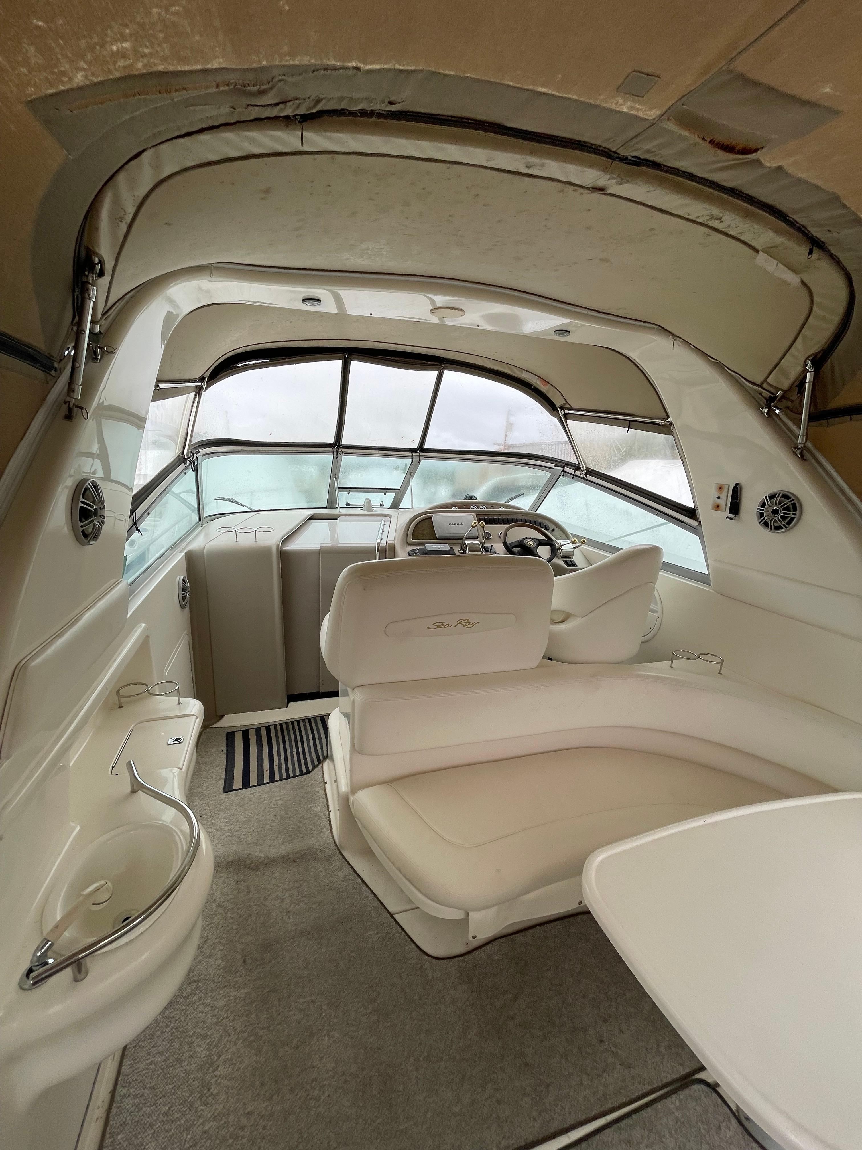 Interior of 2001 Sea Ray 310 Sundancer boat with helm and seating area.
