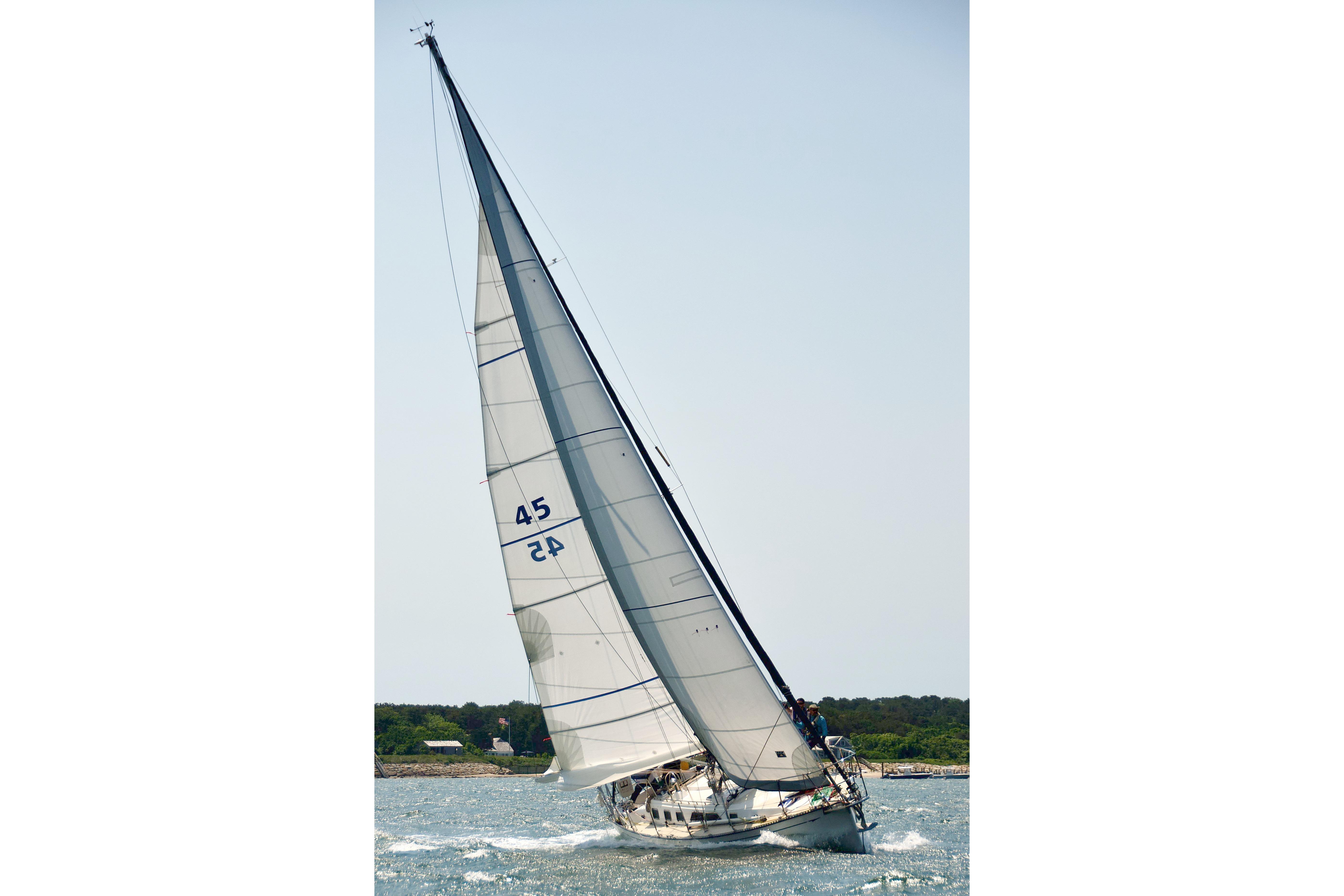 Sailing yacht Saga 43 from 2002 gliding on open water under clear skies.
