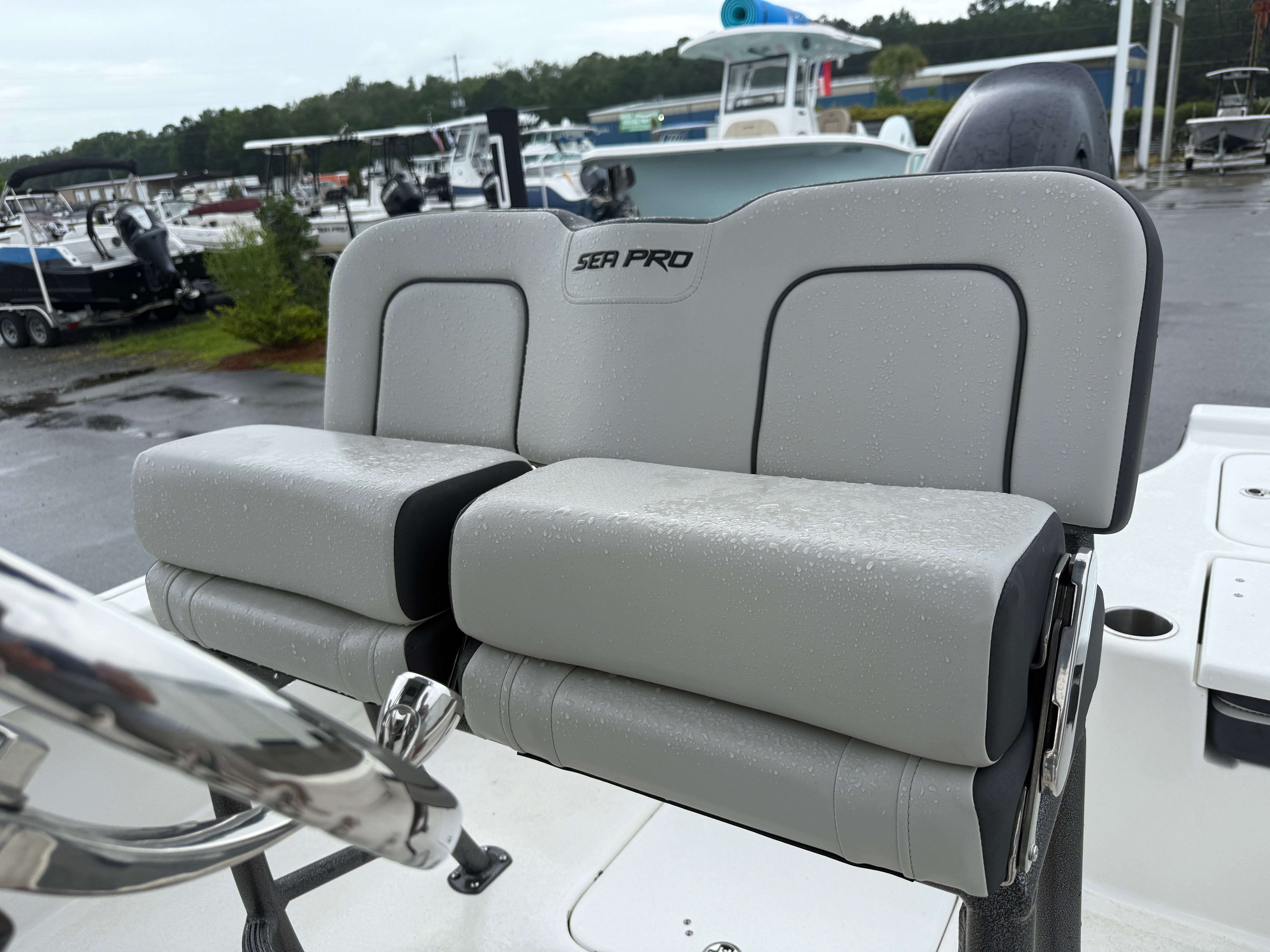 The image shows a gray bench seat on a Sea Pro 230 DLX boat.