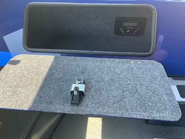 Storage compartment in a 2025 Spartan 240 Maximus Pro with electronic control panel.