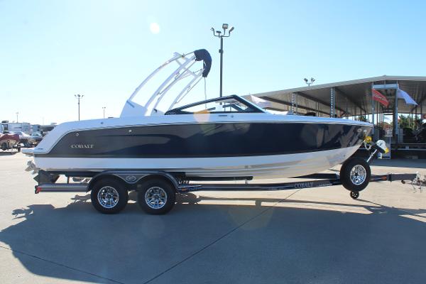 2025 Cobalt CS23 boat on trailer, sleek design, parked outdoors.