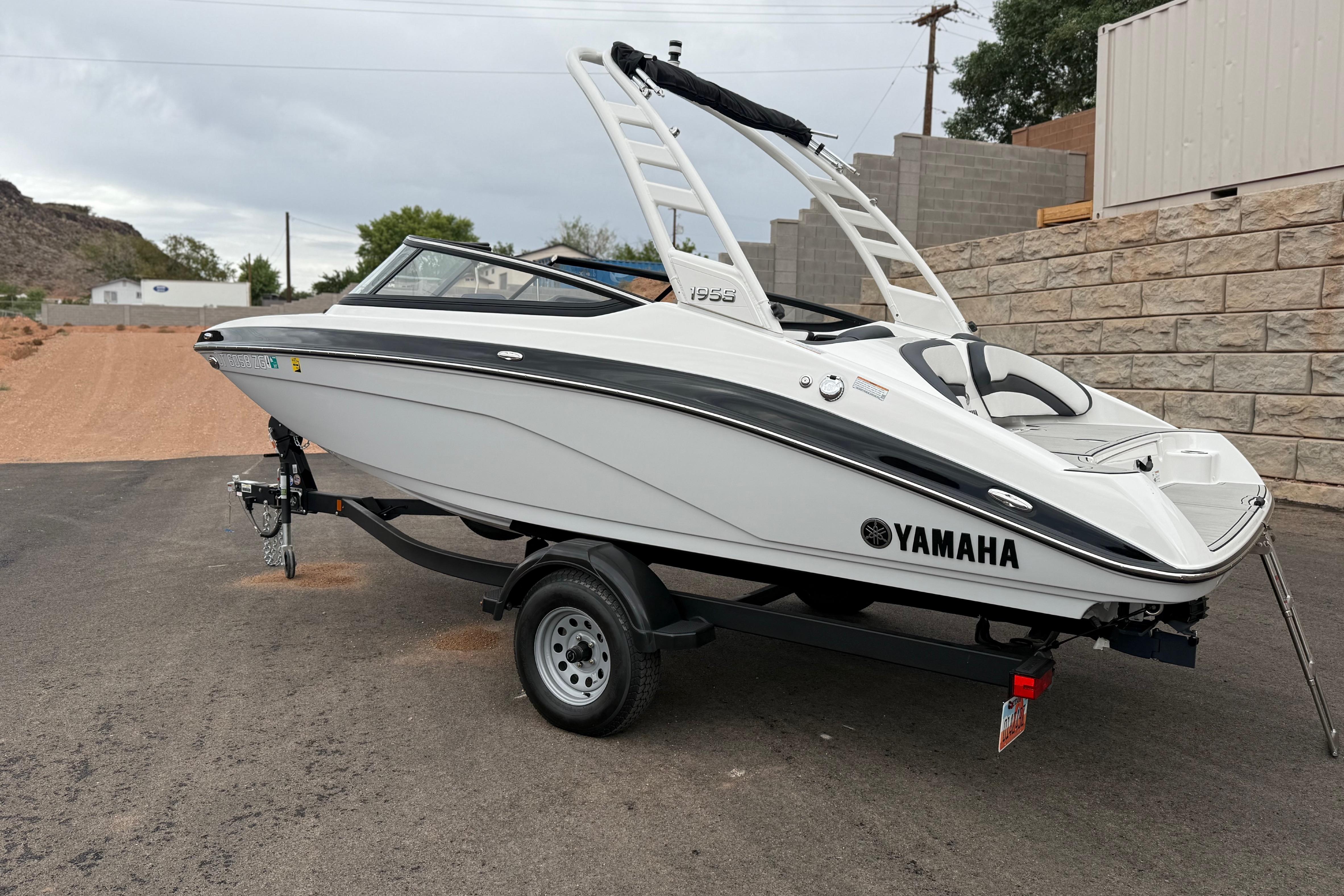 2025 Yamaha Boats 195S on trailer, sleek white design, parked outdoors.