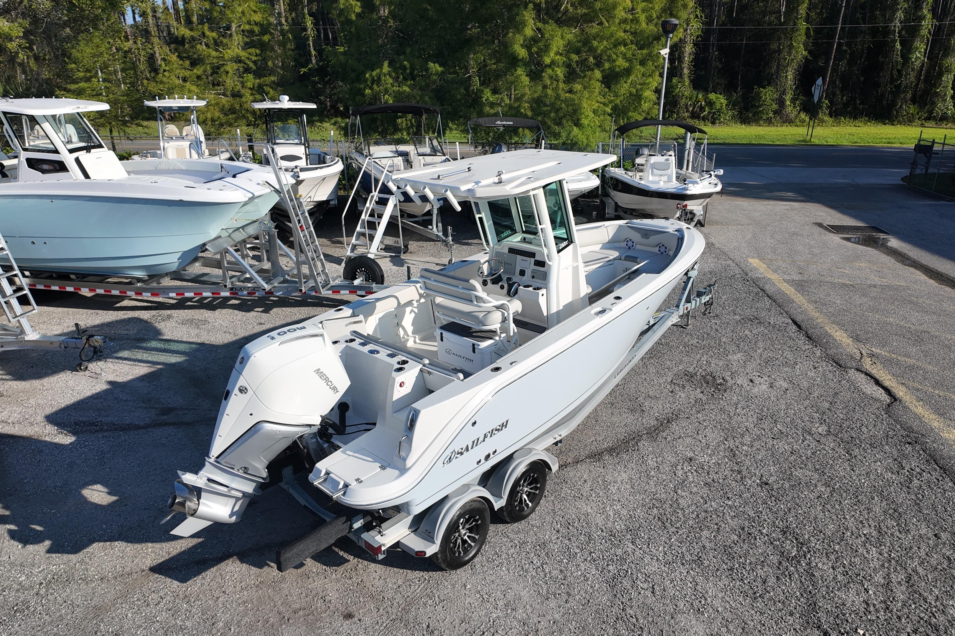 2026 Sailfish 232 CC boat on trailer, parked outdoors with other boats nearby.