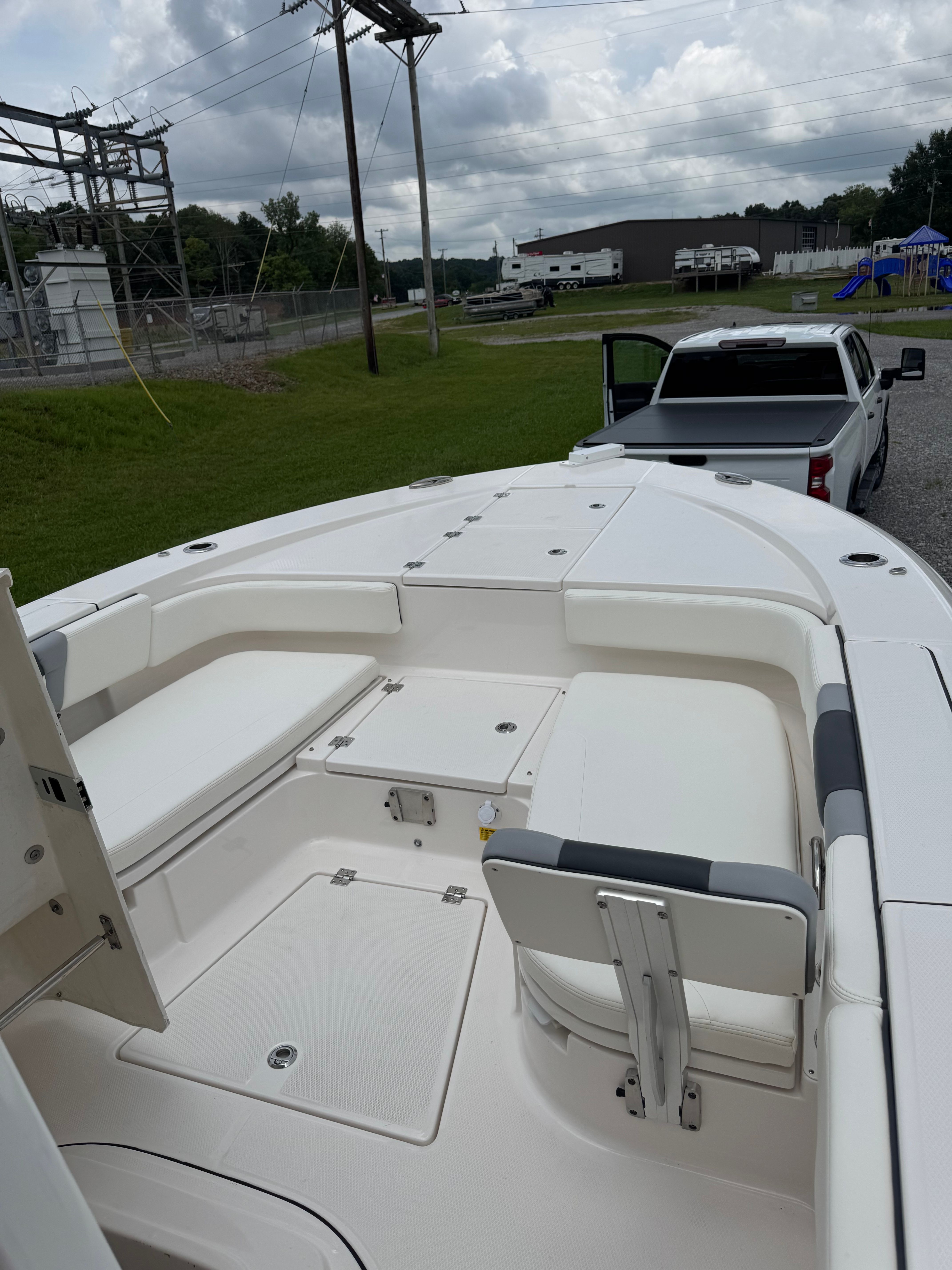 The image shows the deck of a 2023 Robalo 266 Cayman boat on a trailer.