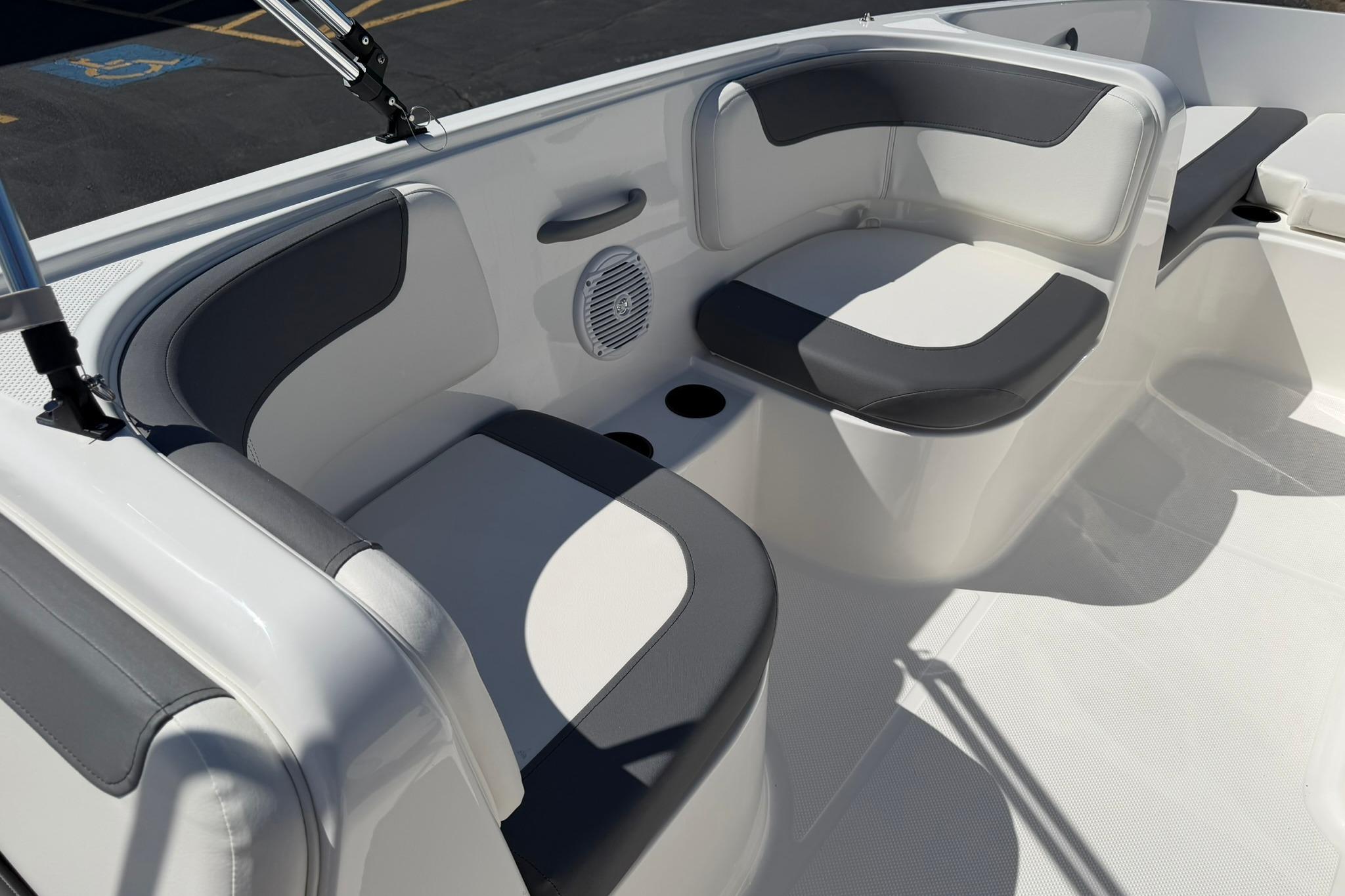 2026 Bayliner Element E18 boat interior with cushioned seating and cup holders.