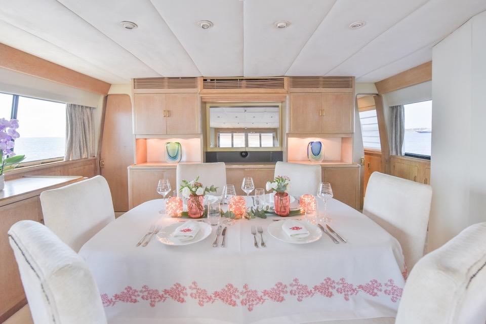 Elegant dining area on a 1984 W.A. Souter & Sons 34 yacht, featuring a beautifully set table.