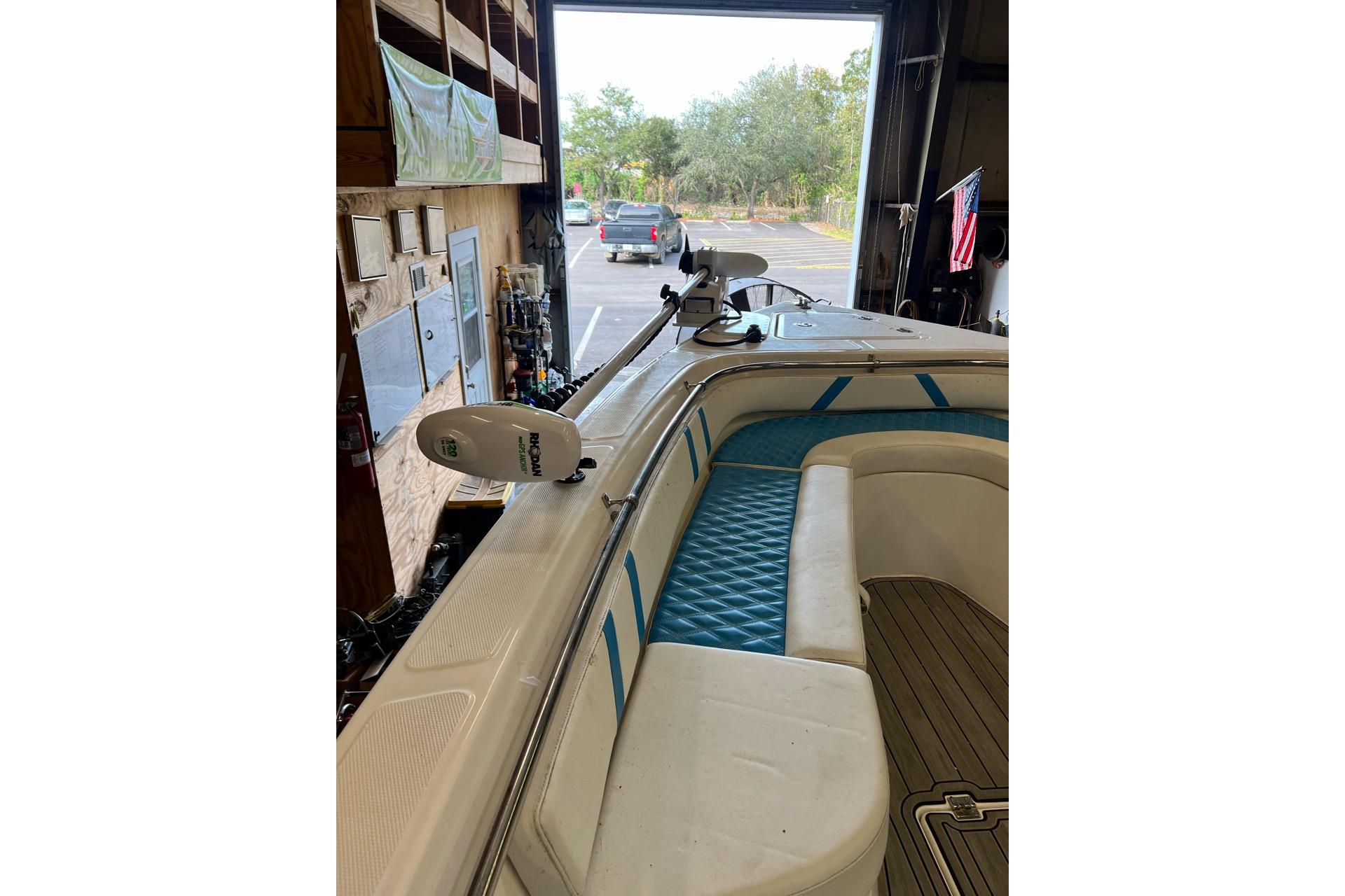 2021 Custom Infusion 34 CC boat interior with blue seating and mounted equipment.