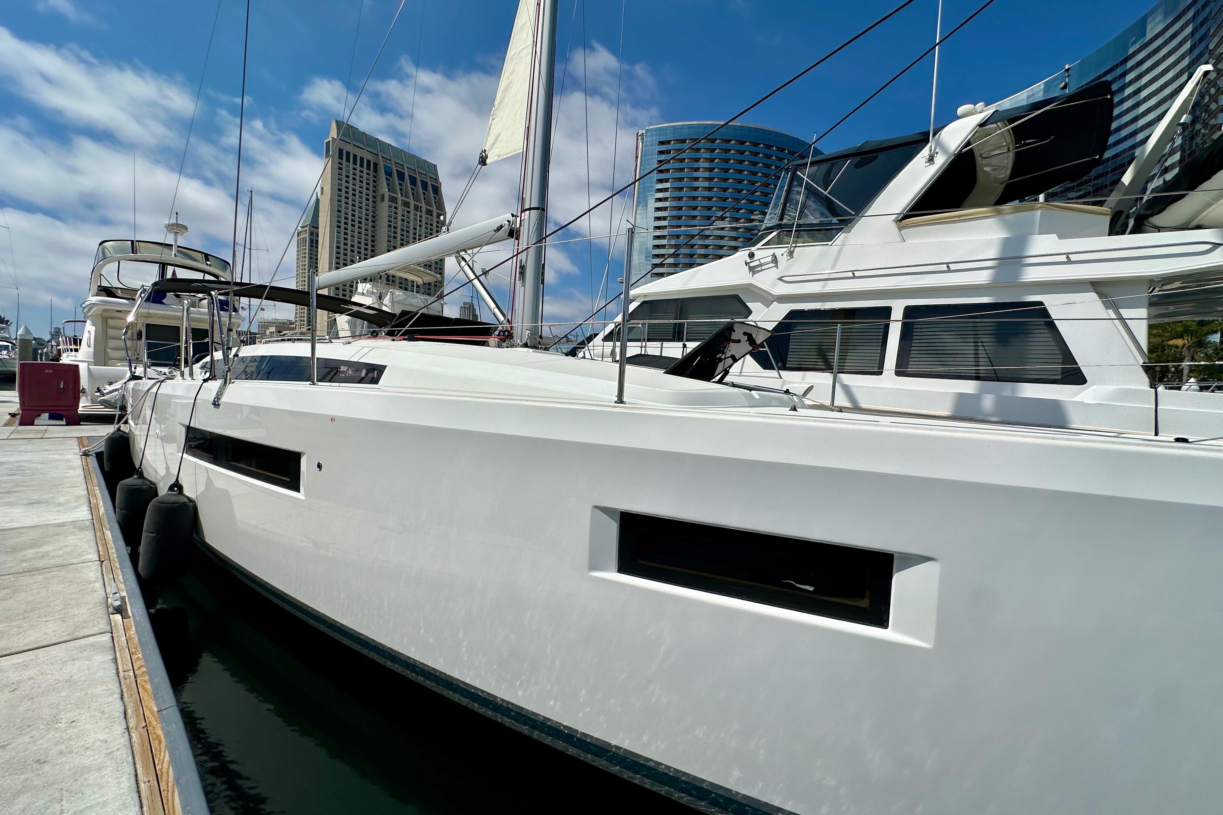 2024 Jeanneau Sun Odyssey 410 yacht docked at marina, modern design, clear sky background.