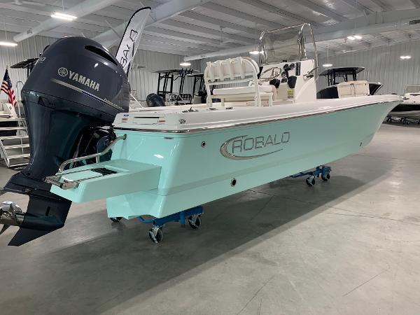2026 Robalo 226 Cayman boat with Yamaha engine in showroom setting.