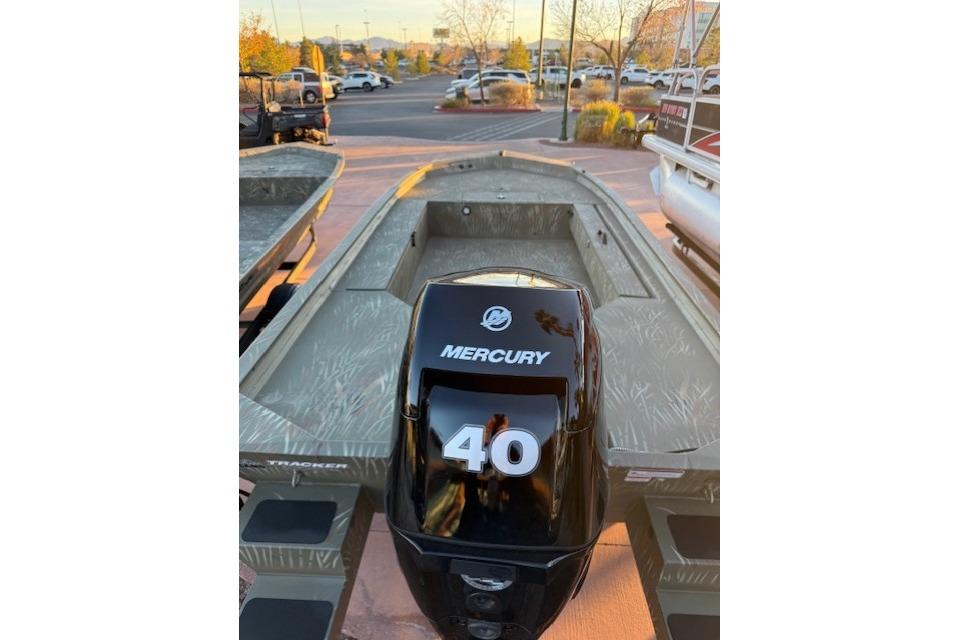 2025 Tracker Grizzly 1654 T Sportsman boat with Mercury 40 engine in parking lot.