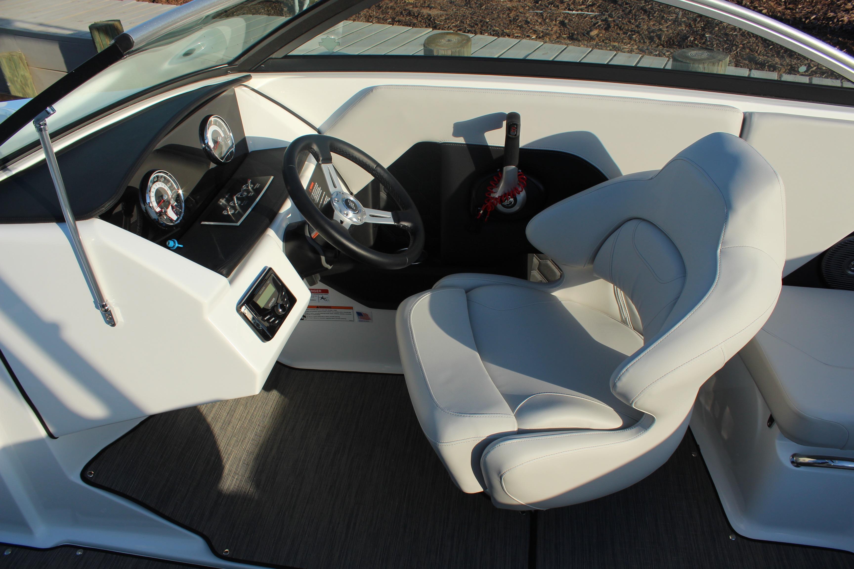 2026 Four Winns H2 Freedom boat cockpit with steering wheel and gauges.