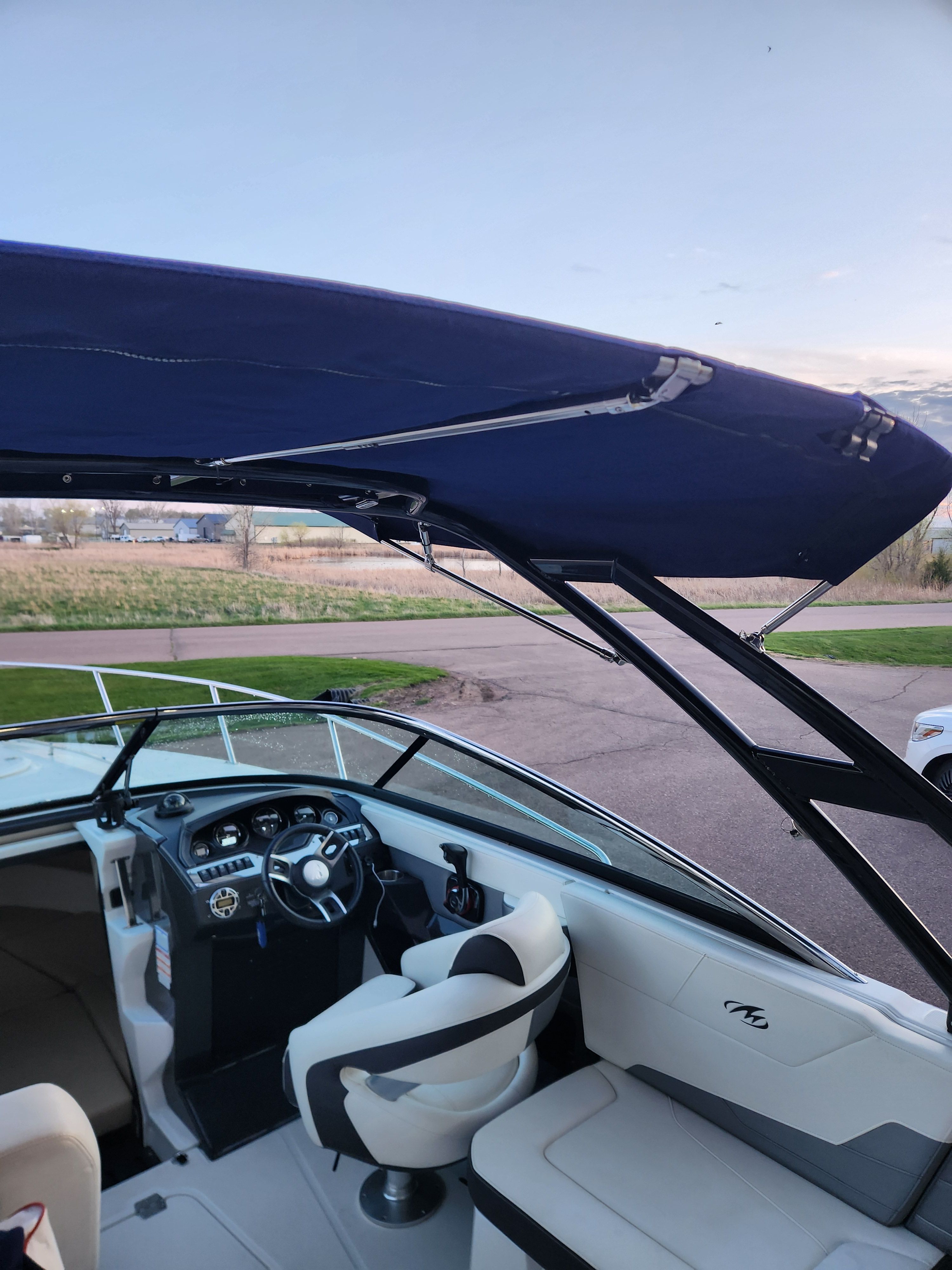 Interior of a 2015 Monterey 268SSC boat with blue canopy.