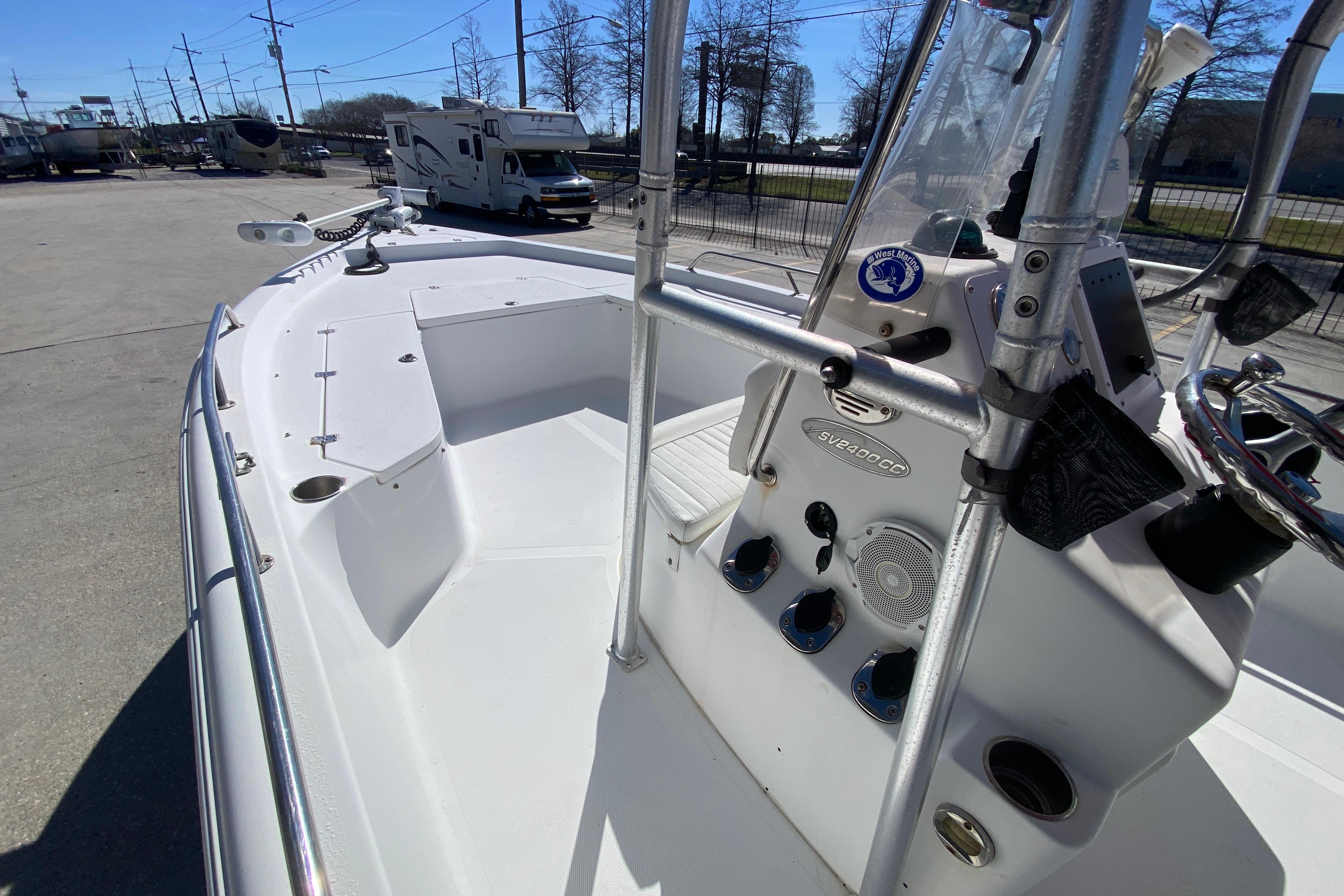 2005 Sea Pro SV2400CC Bay Boat with center console and steering wheel, parked outdoors.