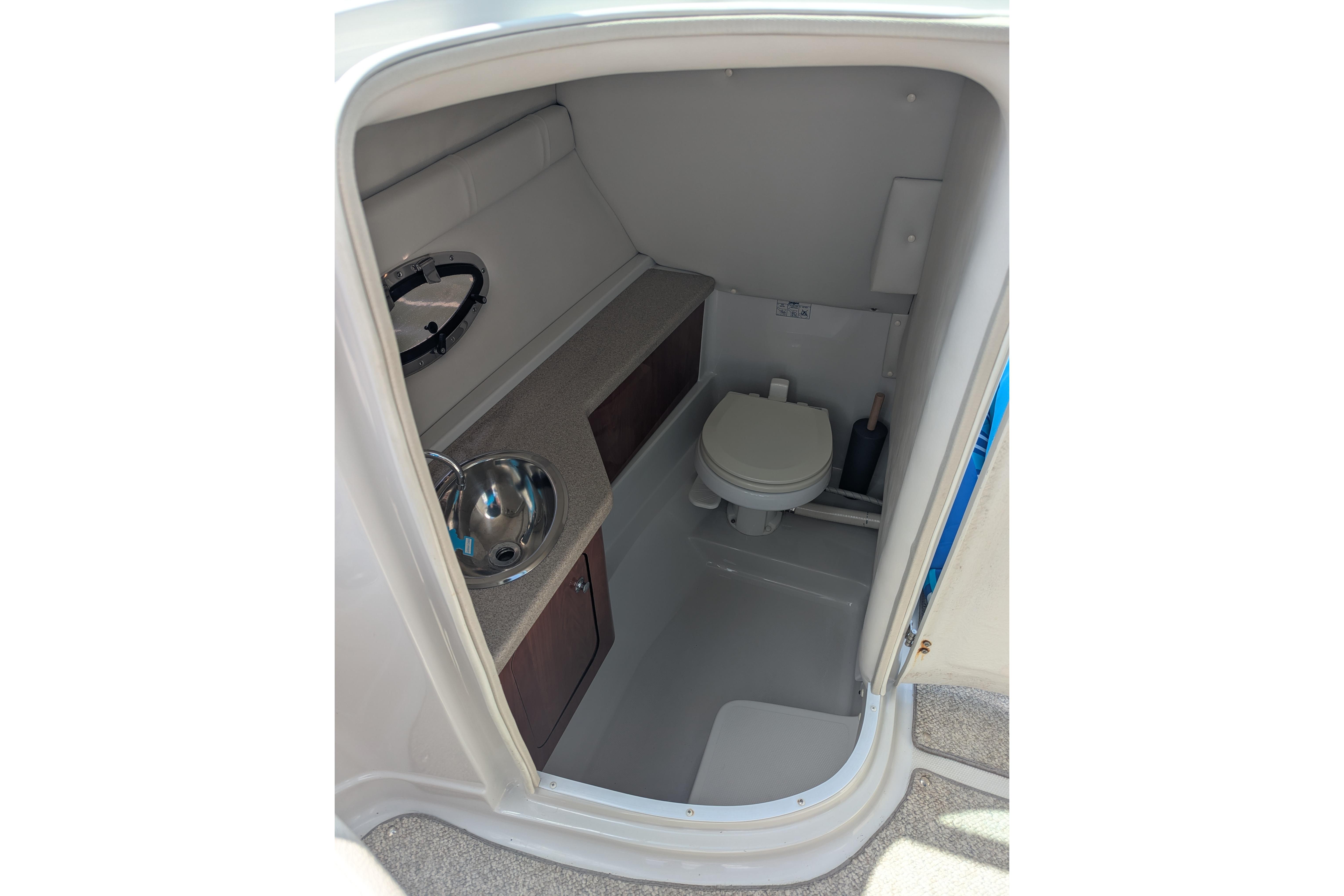 2008 Crownline 300 LS boat interior bathroom with sink and toilet.