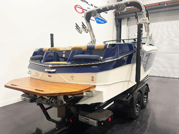 2022 MasterCraft NXT24 boat on trailer in showroom.
